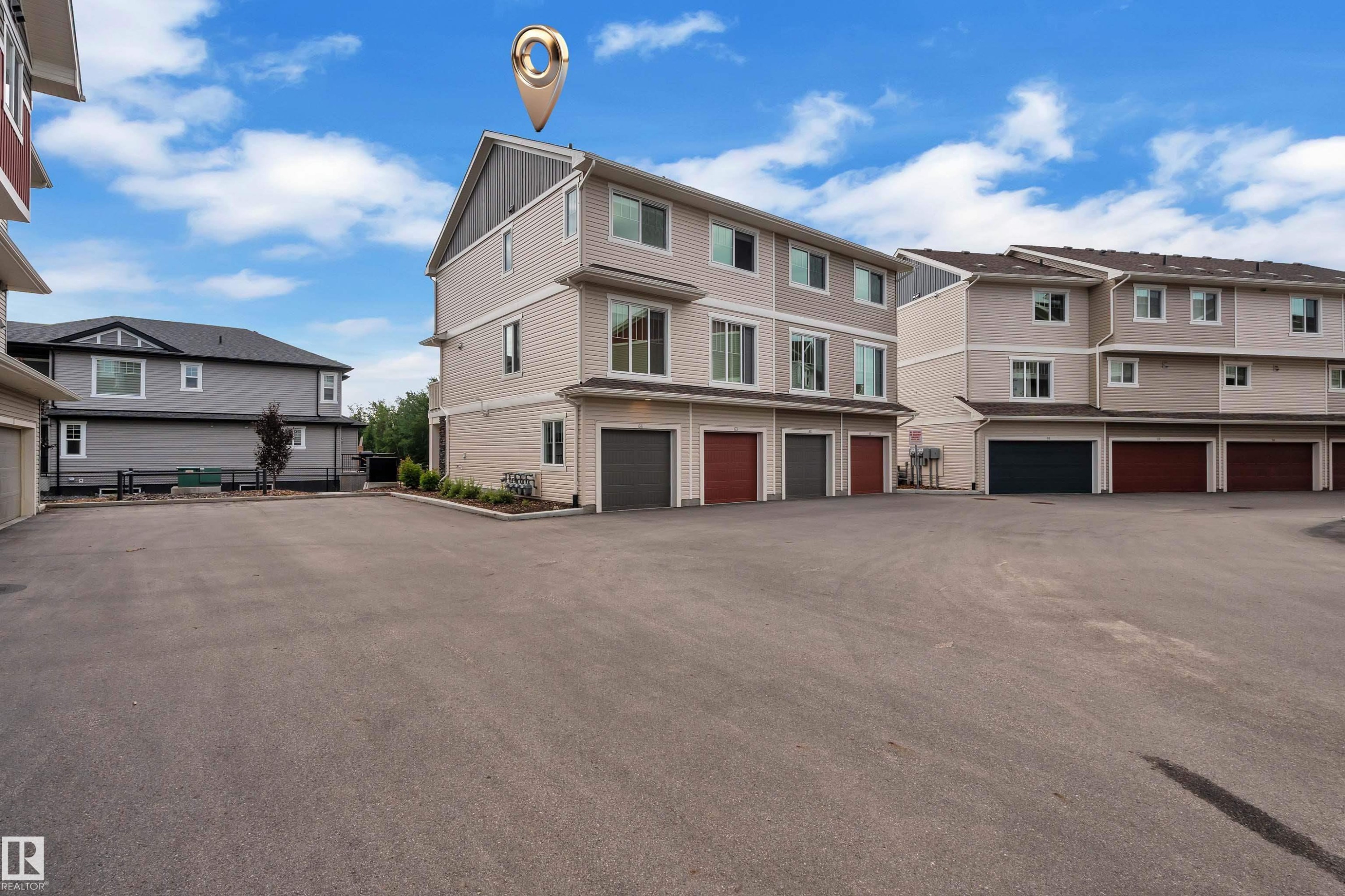 Multi-level townhouse property featuring neutral siding, white trim, and multiple windows - #64 17832 78 St Nw Nw, Edmonton, AB - Outdoor
