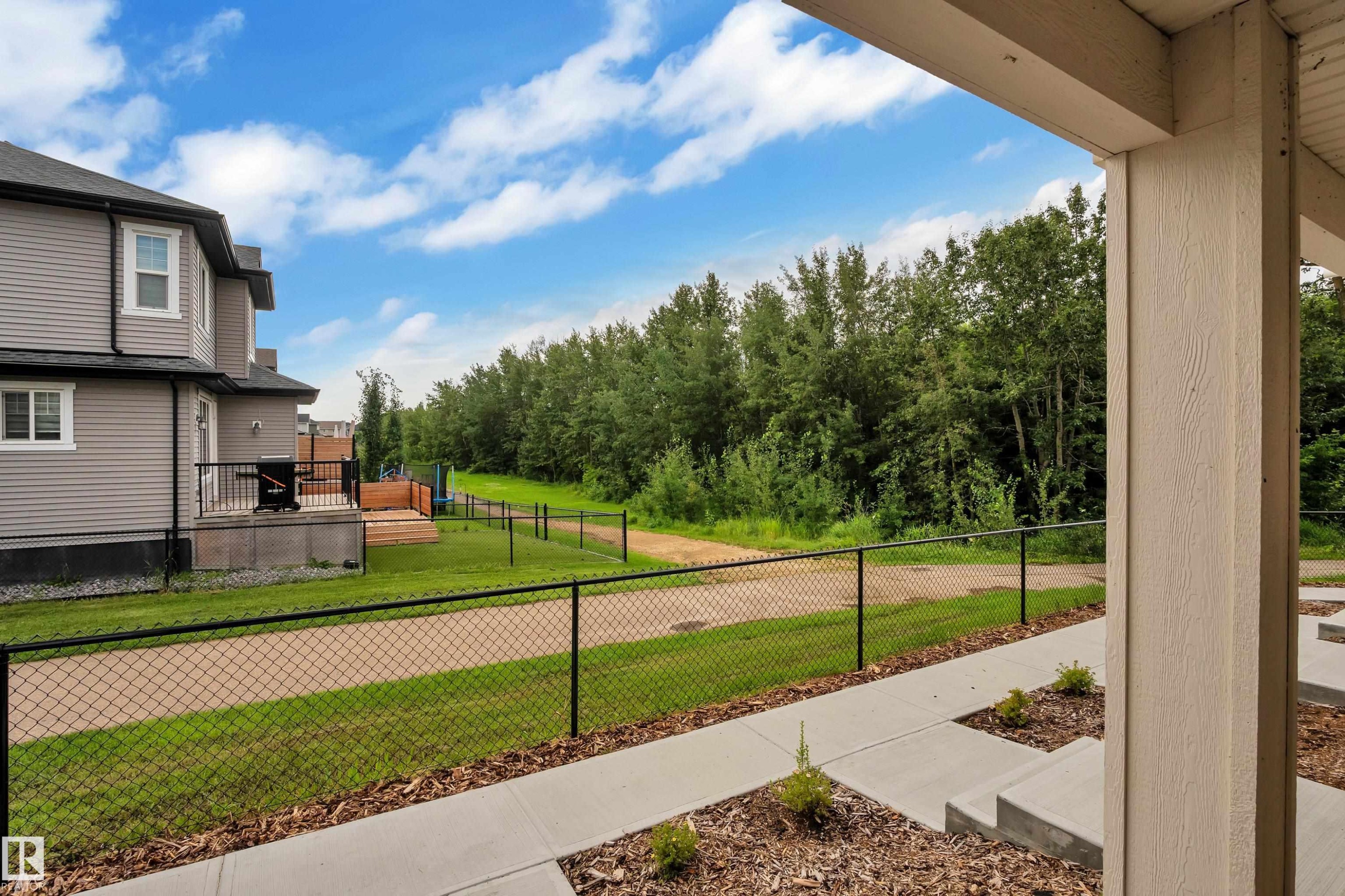 Concrete pathway and steps leading to a front porch with a beige support column - #64 17832 78 St Nw Nw, Edmonton, AB - Outdoor With Exterior