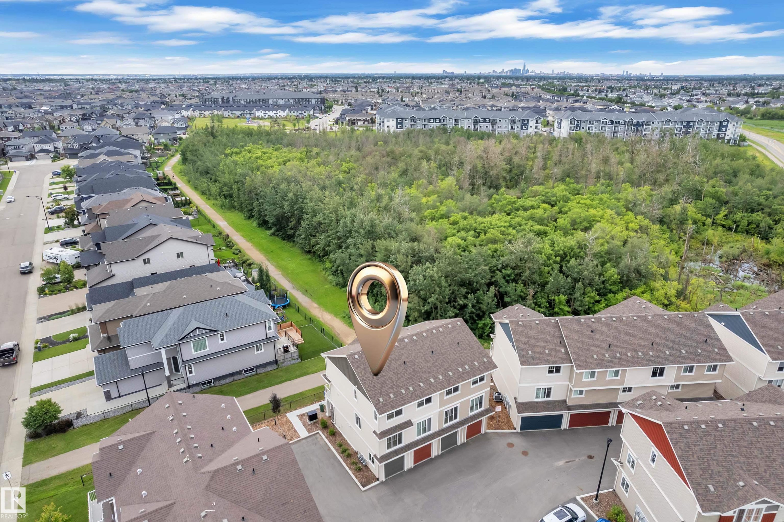 Aerial perspective highlighting a multi-level residential building with light-toned siding and dark shingle roofing, featuring a two-car garage - #64 17832 78 St Nw Nw, Edmonton, AB - Outdoor With View