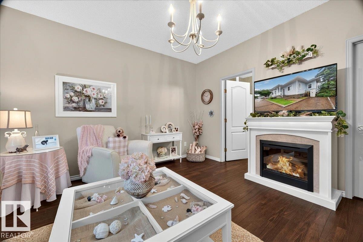 #52 1780 Glastonbury Bv Nw, Edmonton, AB - Indoor Photo Showing Living Room With Fireplace