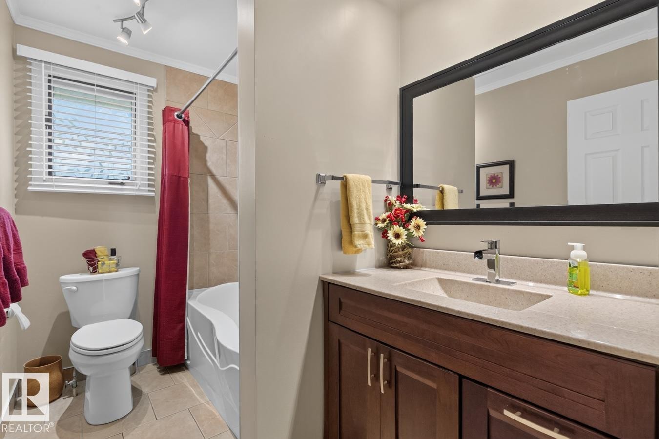 Dual-zone bathroom featuring a wood-finish vanity with dual sinks, quartz countertop, and contemporary matte black framed mirror - 27 Milford Crescent, Sherwood Park, AB - Indoor Photo Showing Bathroom