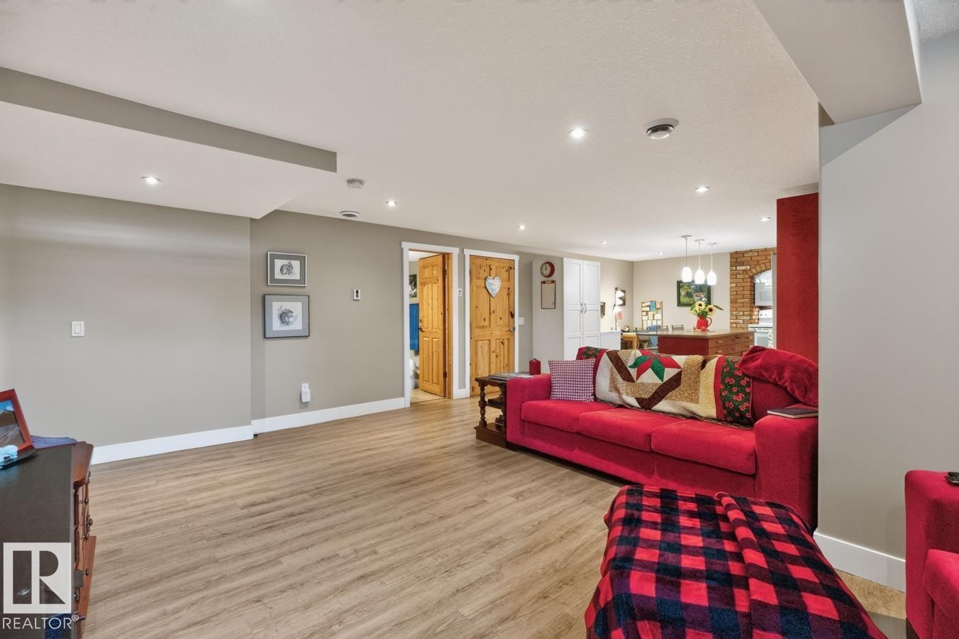 Spacious open-concept room featuring wood-finish flooring, recessed lighting, and neutral wall tones - 27 Milford Crescent, Sherwood Park, AB - Indoor Photo Showing Living Room