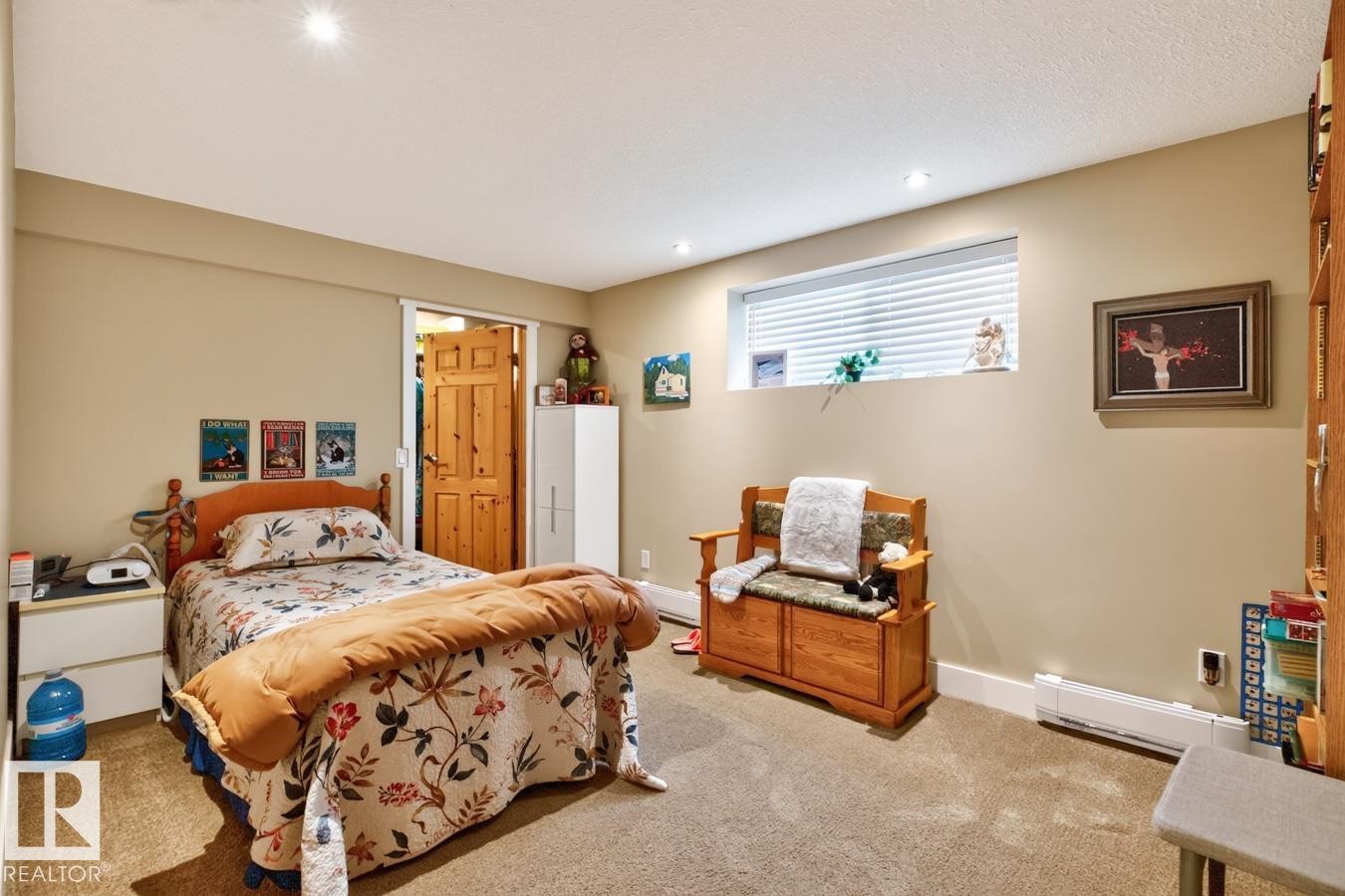 Spacious bedroom with carpeted flooring, recessed ceiling lighting, and abundant natural light from a high window - 27 Milford Crescent, Sherwood Park, AB - Indoor Photo Showing Bedroom
