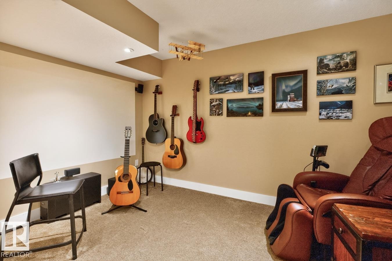 Versatile recreation room featuring neutral wall finishes, carpeted flooring, and abundant natural light from recessed ceiling fixtures - 27 Milford Crescent, Sherwood Park, AB - Indoor