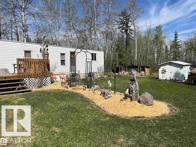 Mobile home with white horizontal siding and a wood deck - 210 55504 Nikoodi Road, Rural Lac Ste. Anne County, AB - Outdoor