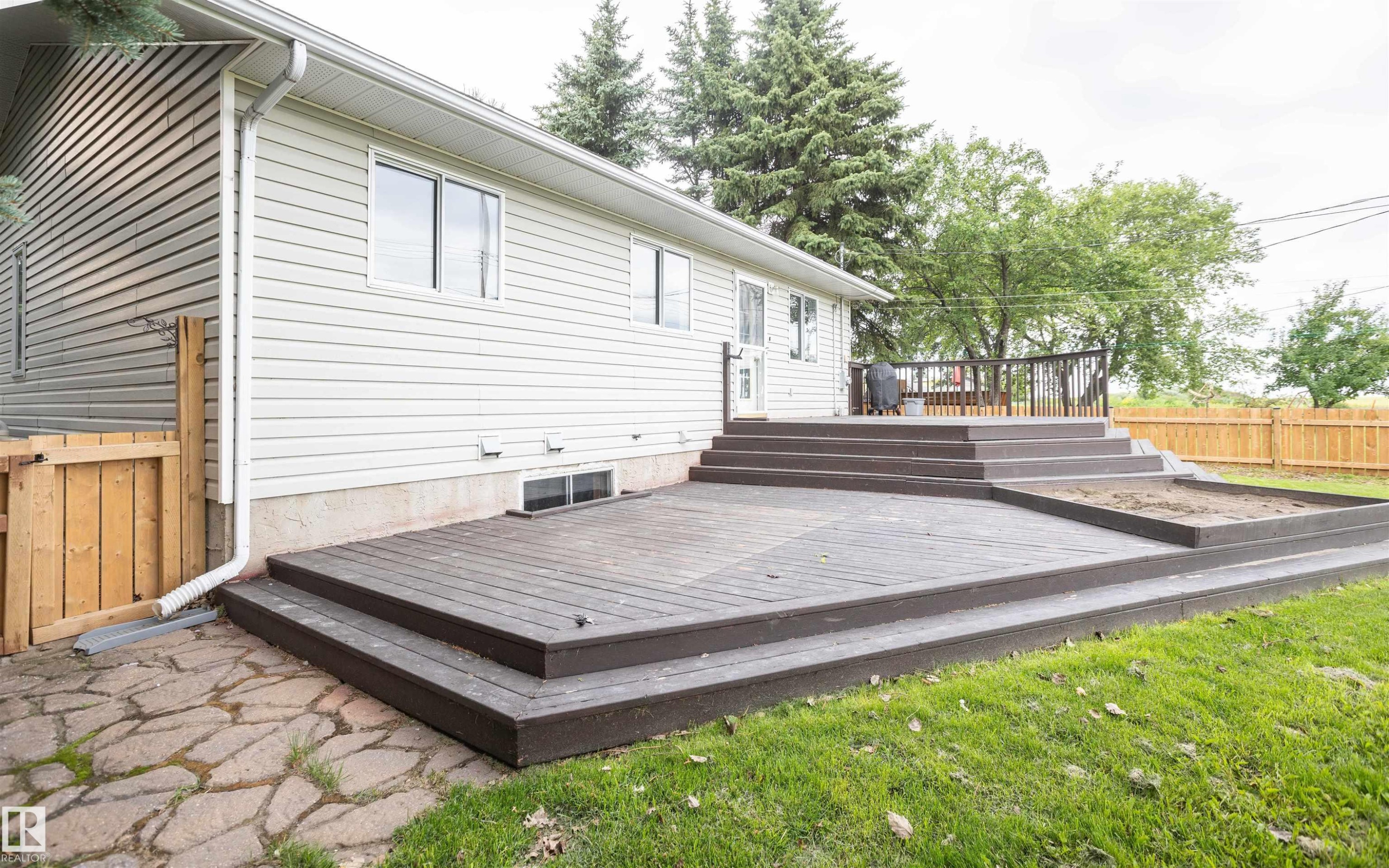 Multi-level deck with composite decking, featuring multiple steps and a raised garden bed - 5116 51 Avenue, Pickardville, AB - Outdoor With Deck Patio Veranda With Exterior