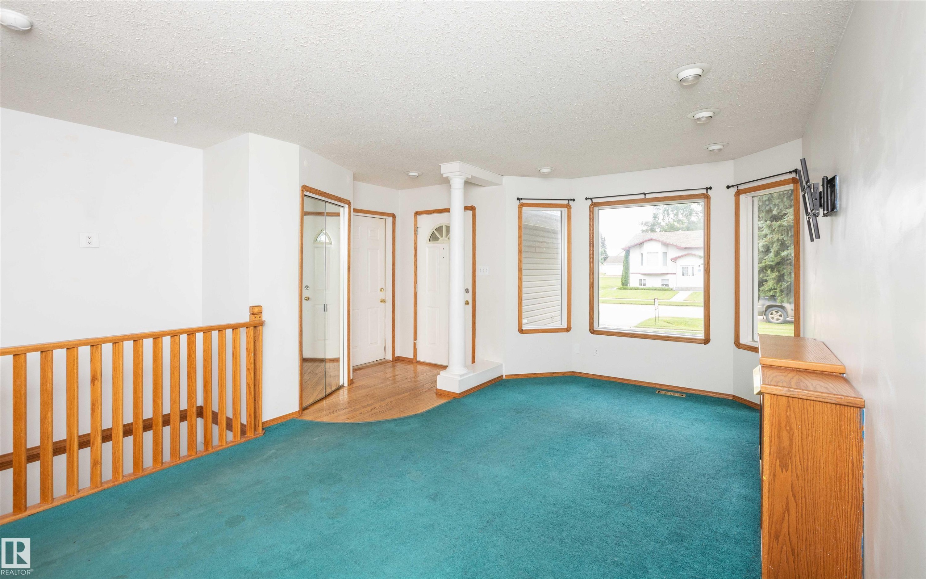 Carpeted living area with a bay window, recessed lighting, and wood-finish trim - 5116 51 Avenue, Pickardville, AB - Indoor Photo Showing Other Room
