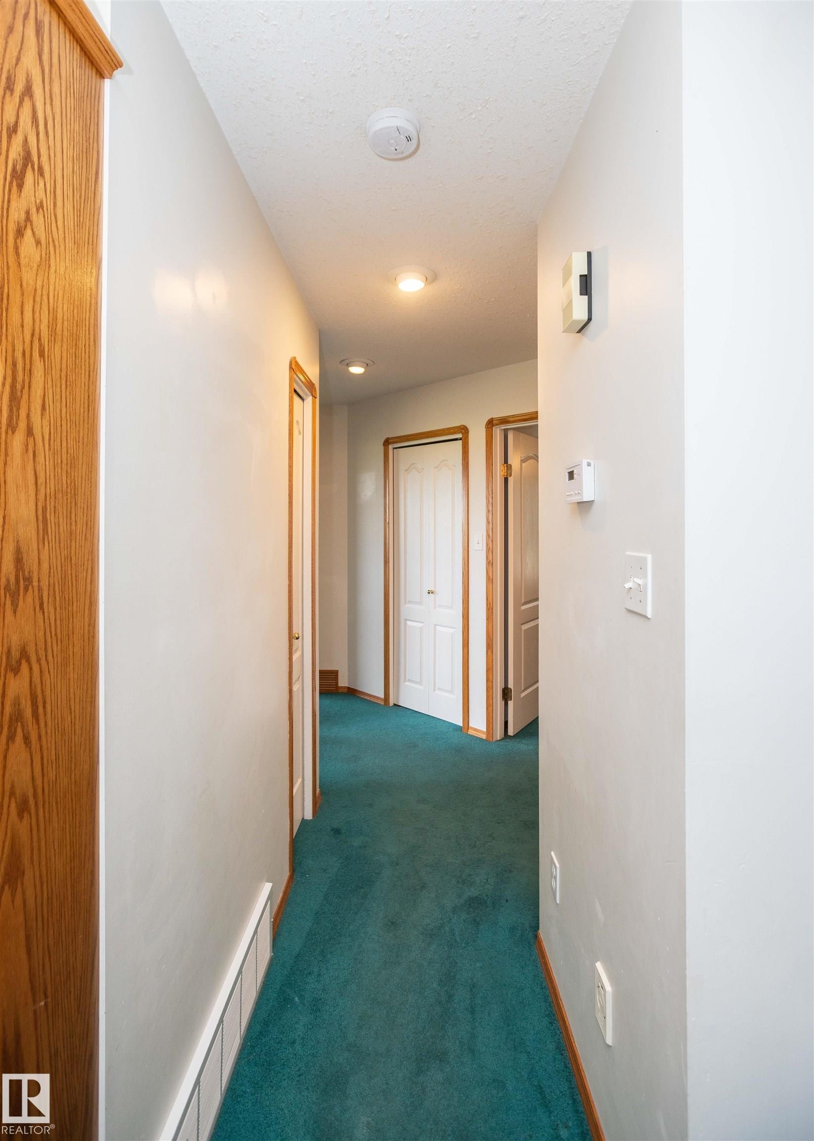 Hallway featuring recessed lighting, a built-in smoke detector, and wood-finish door frames - 5116 51 Avenue, Pickardville, AB - Indoor Photo Showing Other Room