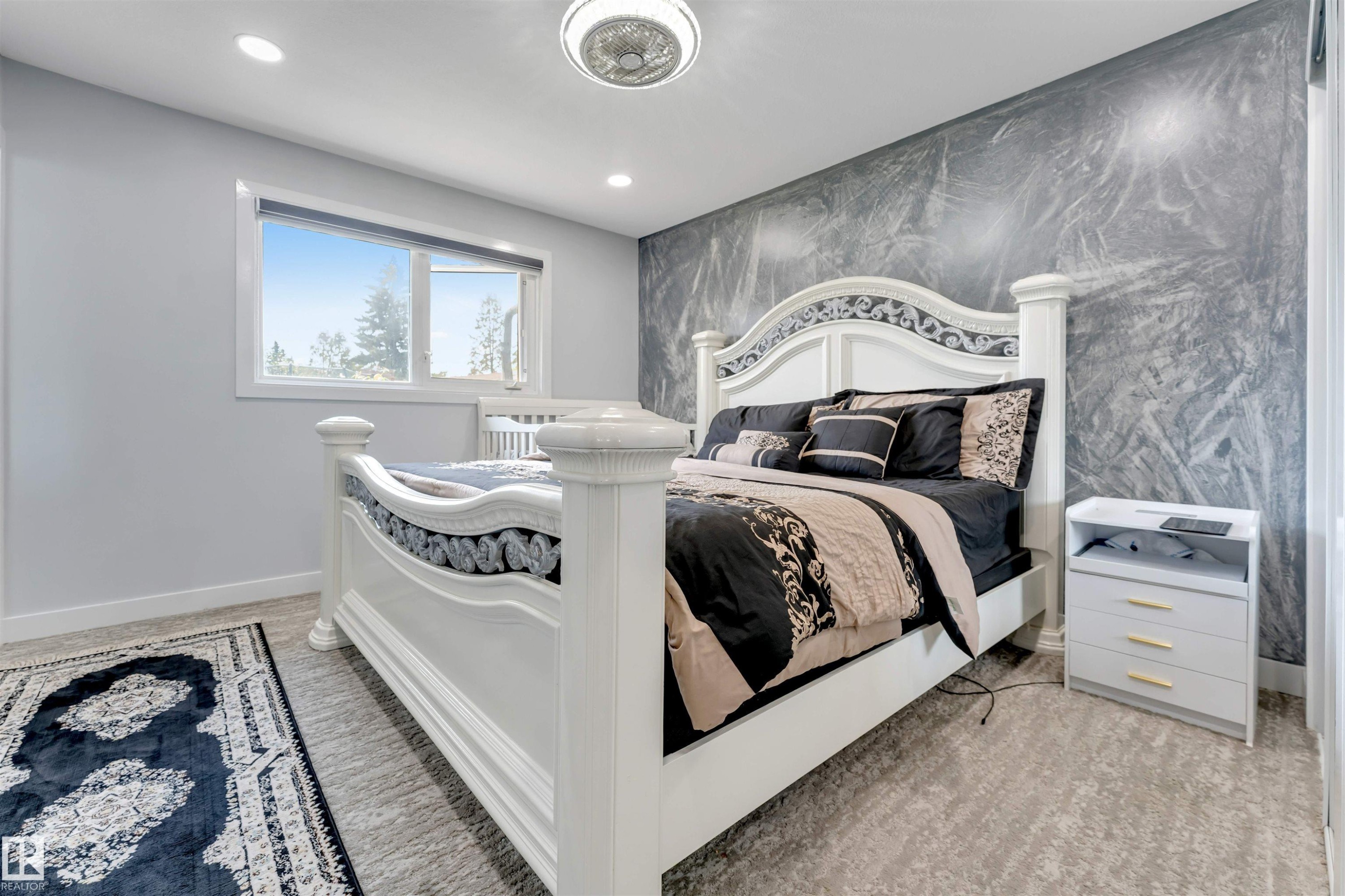 Bedroom featuring a textured accent wall, recessed lighting, and a ceiling fan - 7419 33 Avenue Nw, Edmonton, AB - Indoor Photo Showing Bedroom