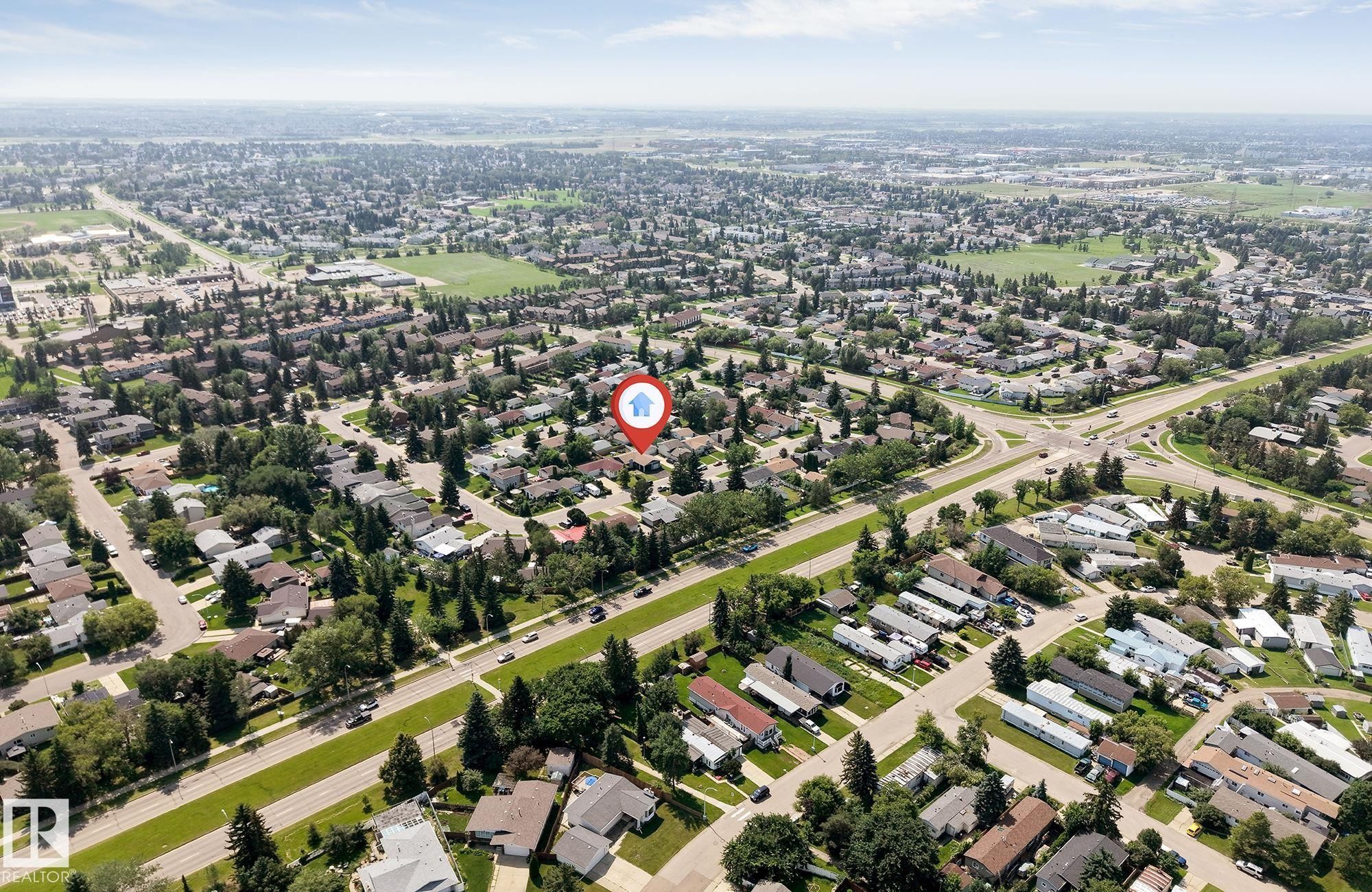 Expansive aerial view showcasing a residential neighborhood with detached homes, mature trees, and arterial roads - 7419 33 Avenue Nw, Edmonton, AB - Outdoor With View