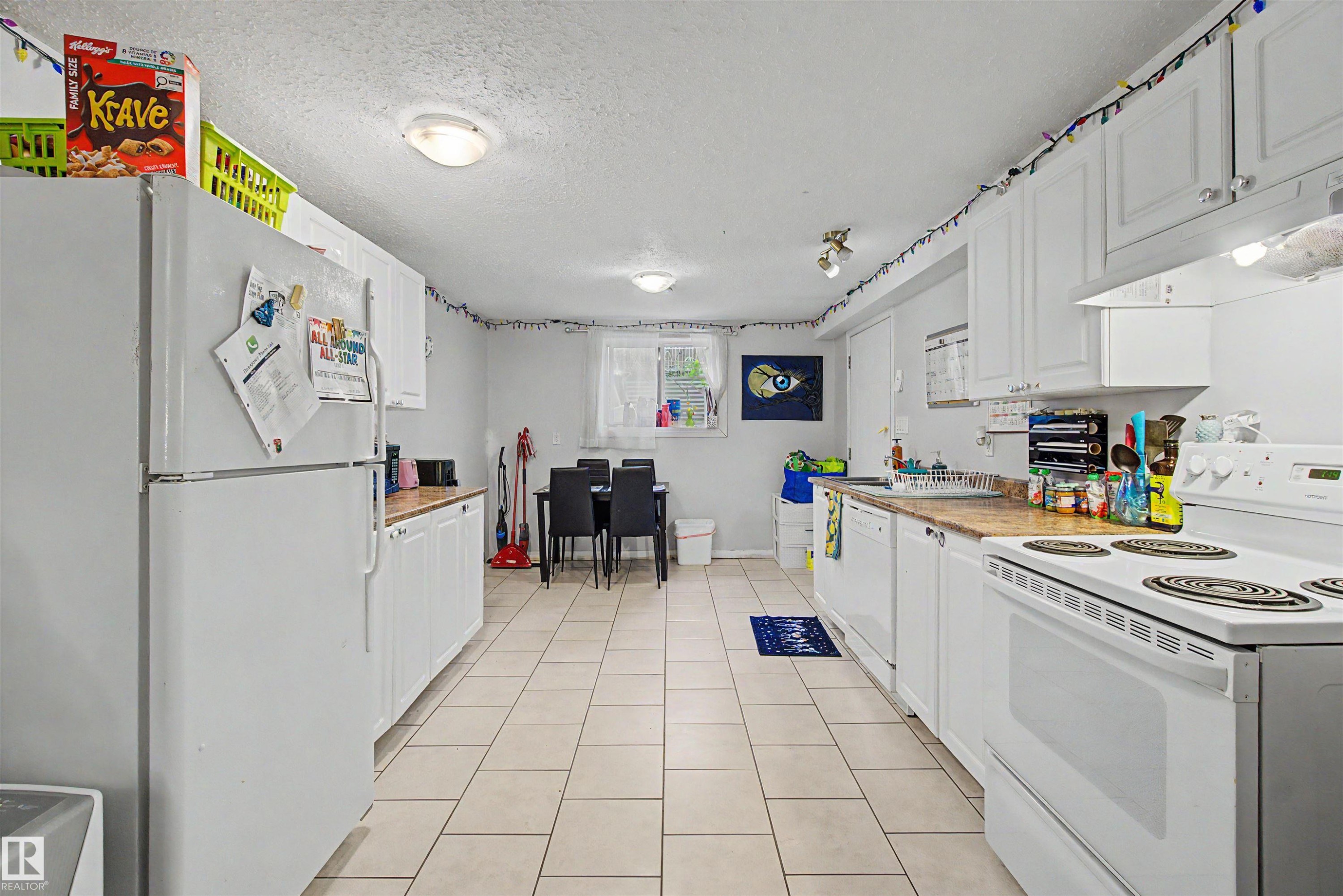 Kitchen with white cabinetry, light countertops, and tile flooring - 8215 149 Street Nw, Edmonton, AB - Indoor Photo Showing Kitchen