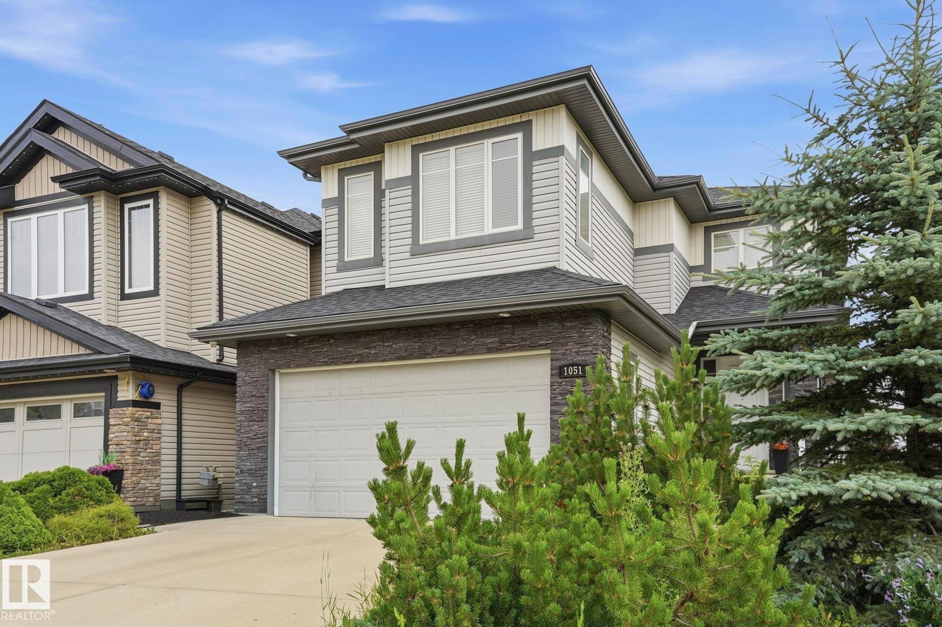 Contemporary two-story exterior featuring a stone and siding facade - 1051 174 Street Sw, Edmonton, AB - Outdoor