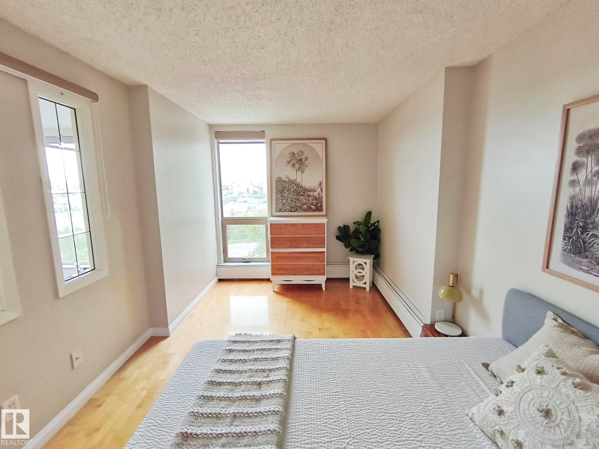Bright interior space featuring light wood-finish flooring and neutral wall tones - #509 10149 Saskatchewan Dr Nw, Edmonton, AB - Indoor Photo Showing Bedroom