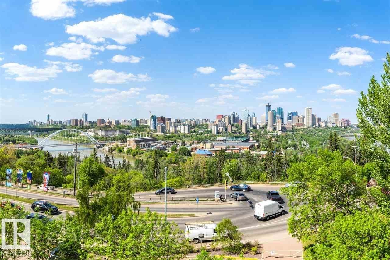 Expansive skyline featuring a collection of high-rise buildings, a river, a prominent arched bridge, and surrounding green spaces - #509 10149 Saskatchewan Dr Nw, Edmonton, AB - Outdoor With View