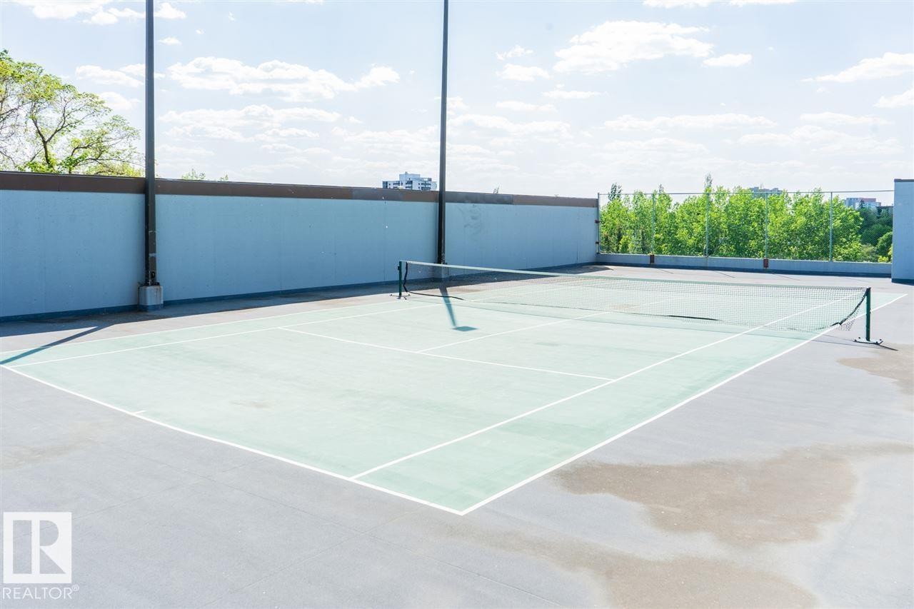 Outdoor tennis court with a hard surface, perimeter fencing, and integrated lighting fixtures - #509 10149 Saskatchewan Dr Nw, Edmonton, AB -