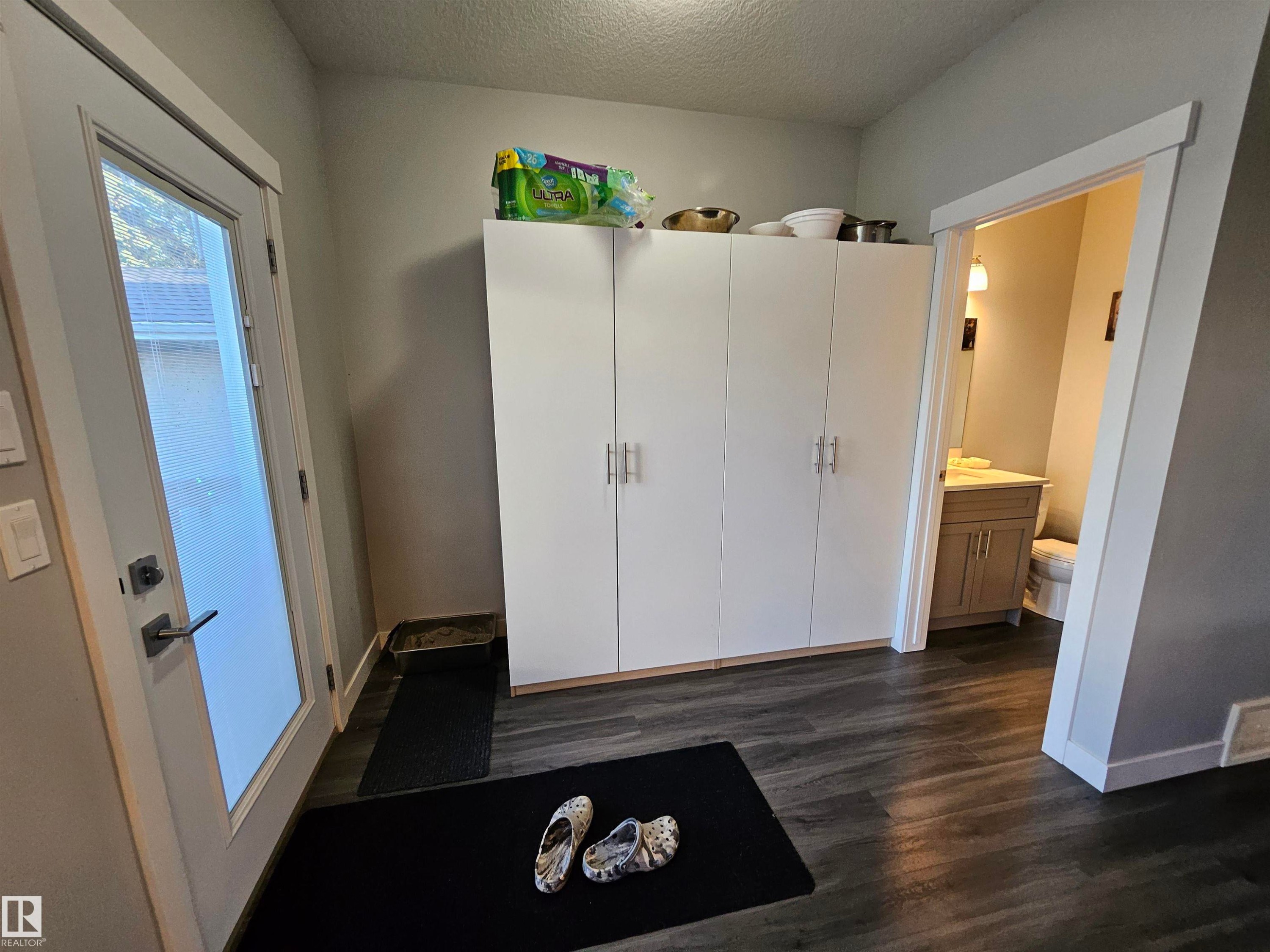 Floor-to-ceiling white cabinetry providing extensive storage - 13309 104 Street Nw, Edmonton, AB - Indoor Photo Showing Other Room