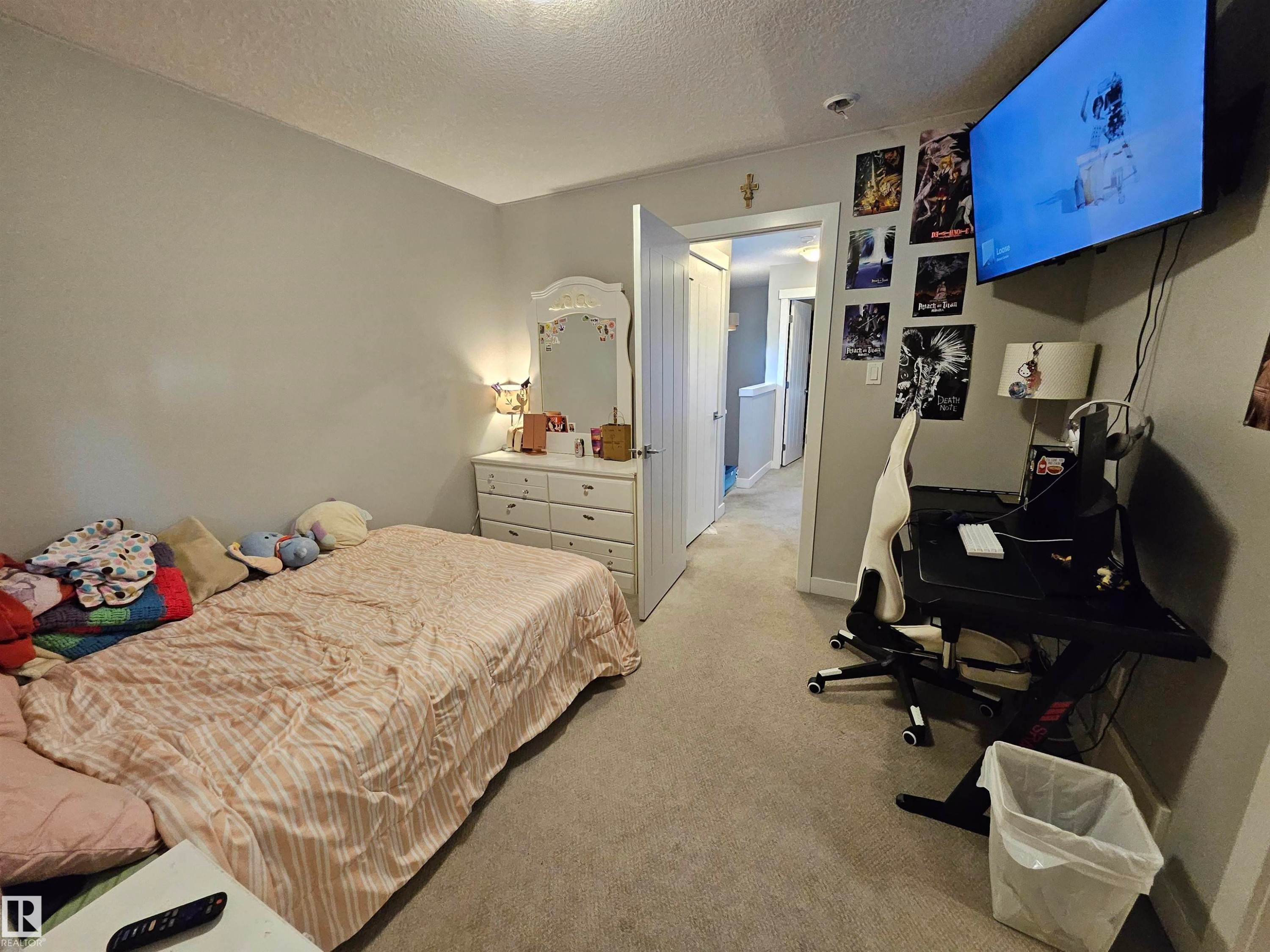 Wall-to-wall carpeting in a neutral tone, light gray painted walls, and white trim throughout - 13309 104 Street Nw, Edmonton, AB - Indoor Photo Showing Bedroom