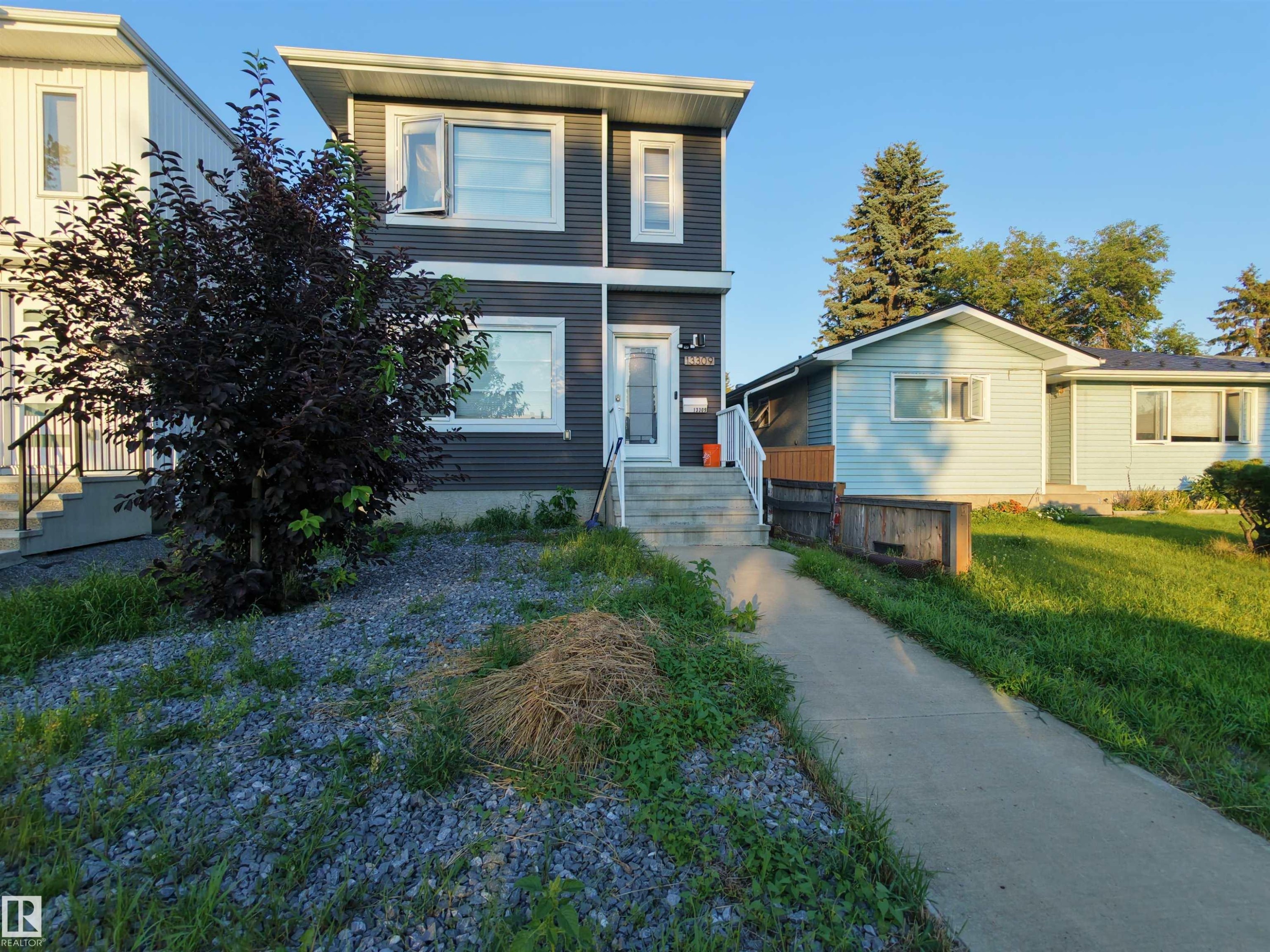 Two-story residence featuring dark gray horizontal siding and white trim - 13309 104 Street Nw, Edmonton, AB - Outdoor