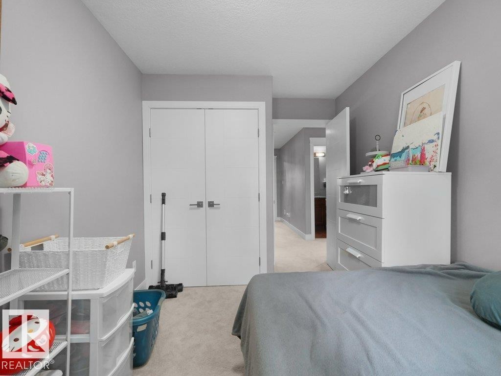Interior room featuring neutral gray wall paint and light-colored carpet flooring - 7909 105 Avenue Nw, Edmonton, AB - Indoor Photo Showing Bedroom