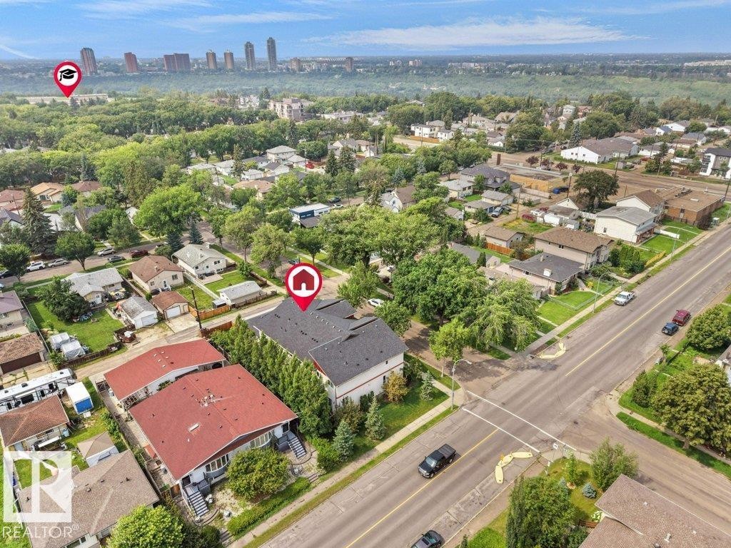 Aerial perspective showcasing a residential area with varied housing styles - 7909 105 Avenue Nw, Edmonton, AB - Outdoor With View