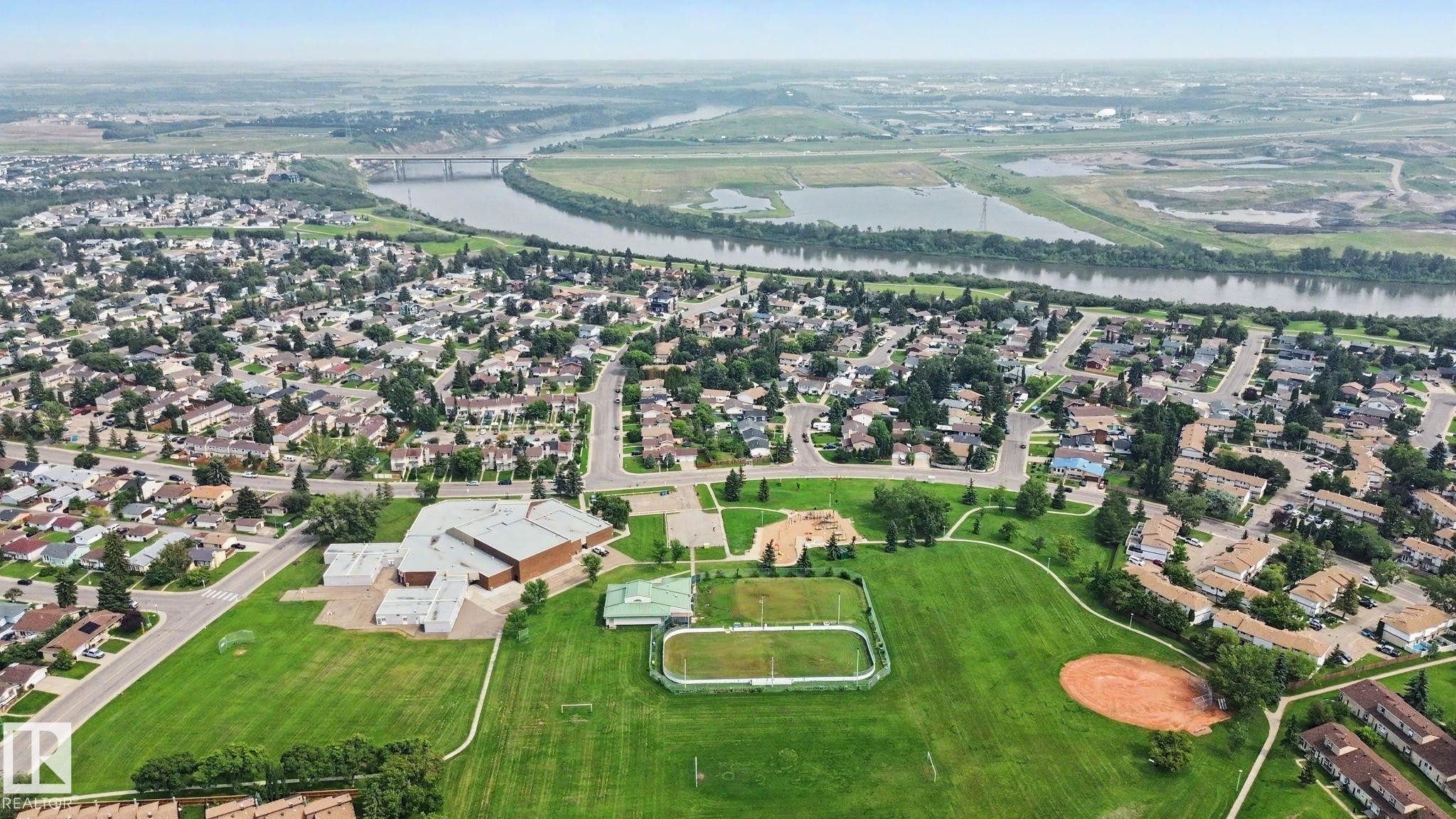 Aerial perspective showcasing a residential community with abundant green spaces - #39 3111 142 Av Nw, Edmonton, AB - Outdoor With View