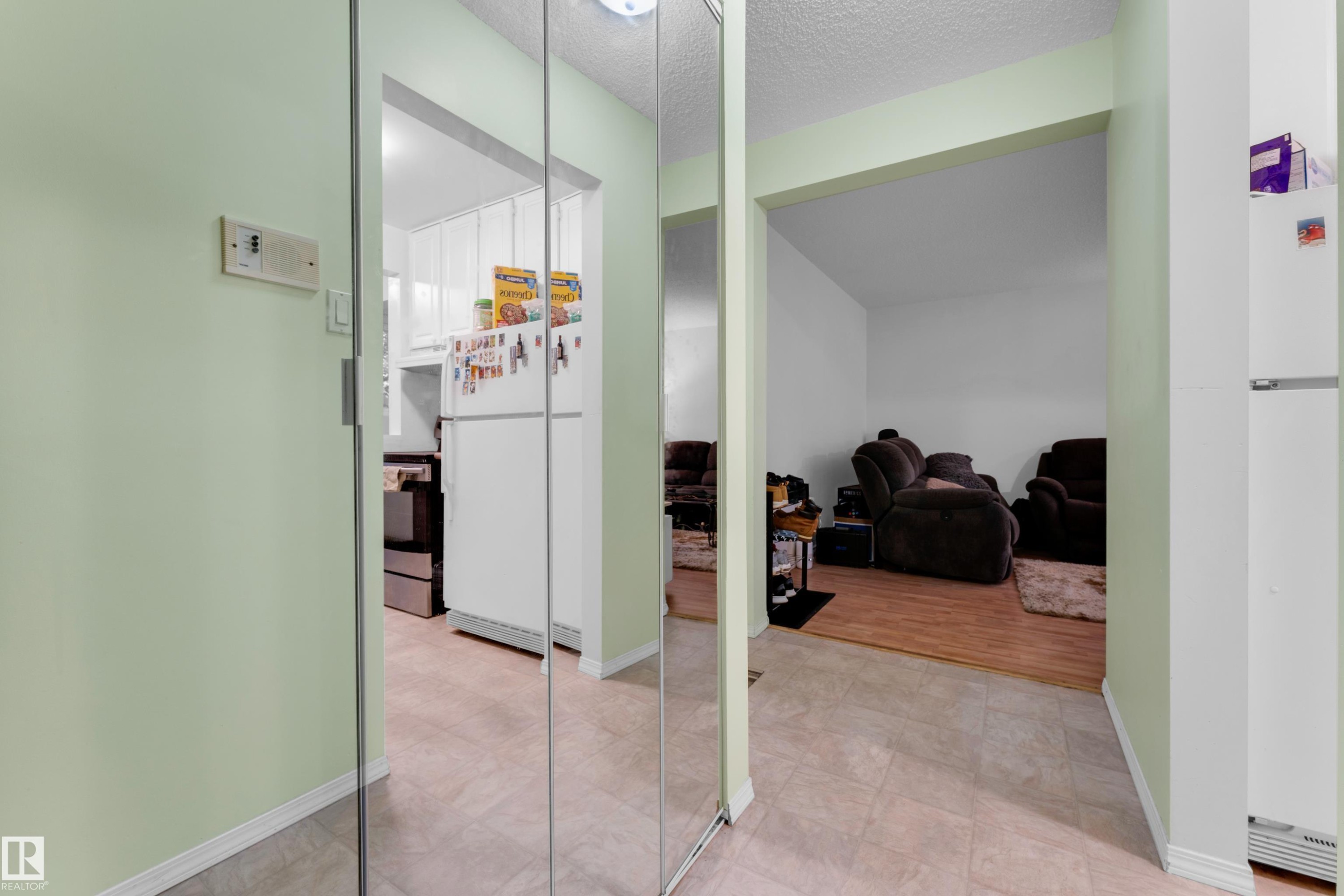 Mirrored closet doors providing a bright aesthetic - #104 11445 41 Av Nw, Edmonton, AB - Indoor Photo Showing Other Room
