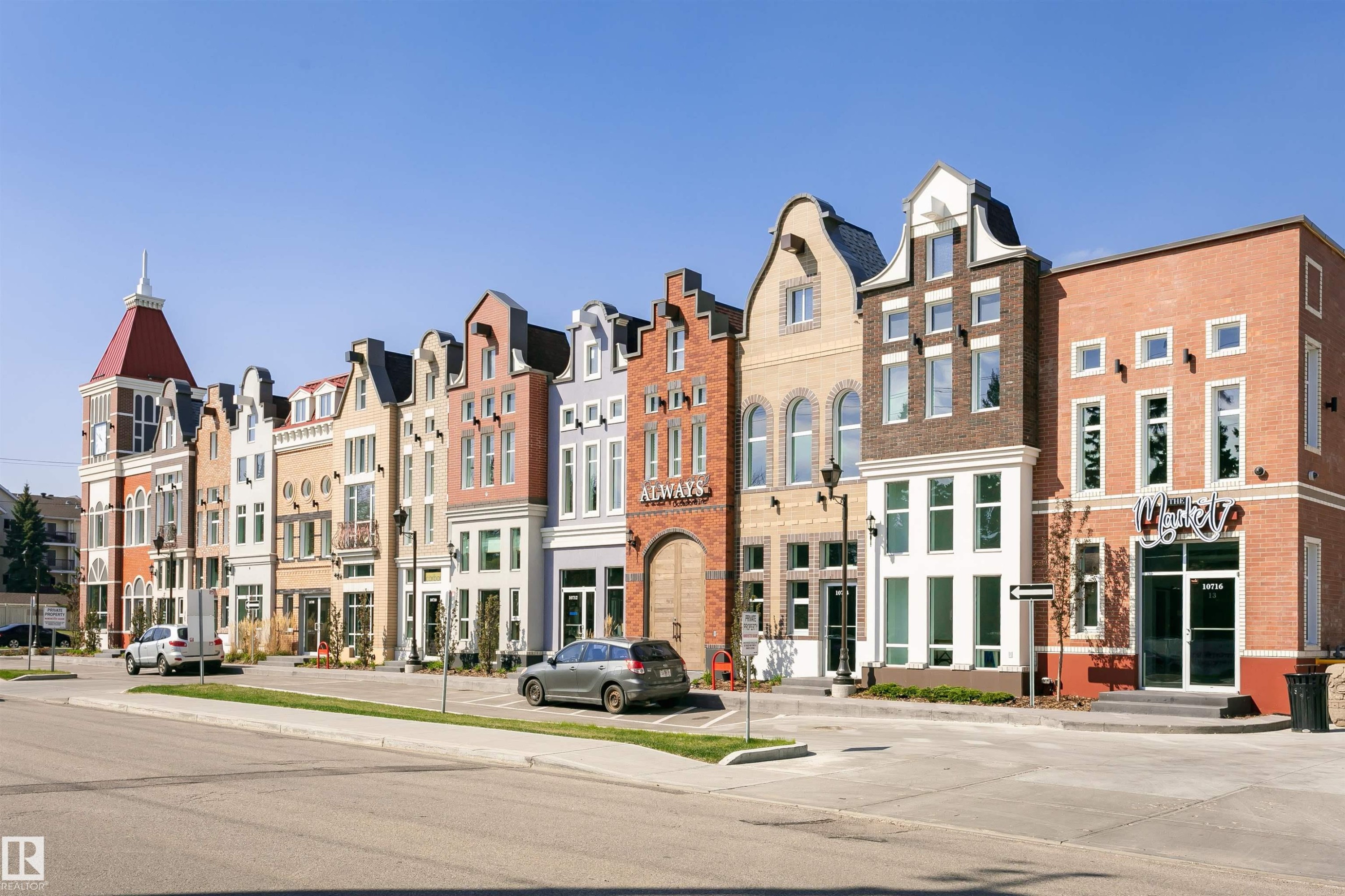 Mixed-use architectural development featuring varied facades, multiple stories, distinct window designs, and street-level retail spaces - #106 12110 106 Av Nw, Edmonton, AB - Outdoor With Facade