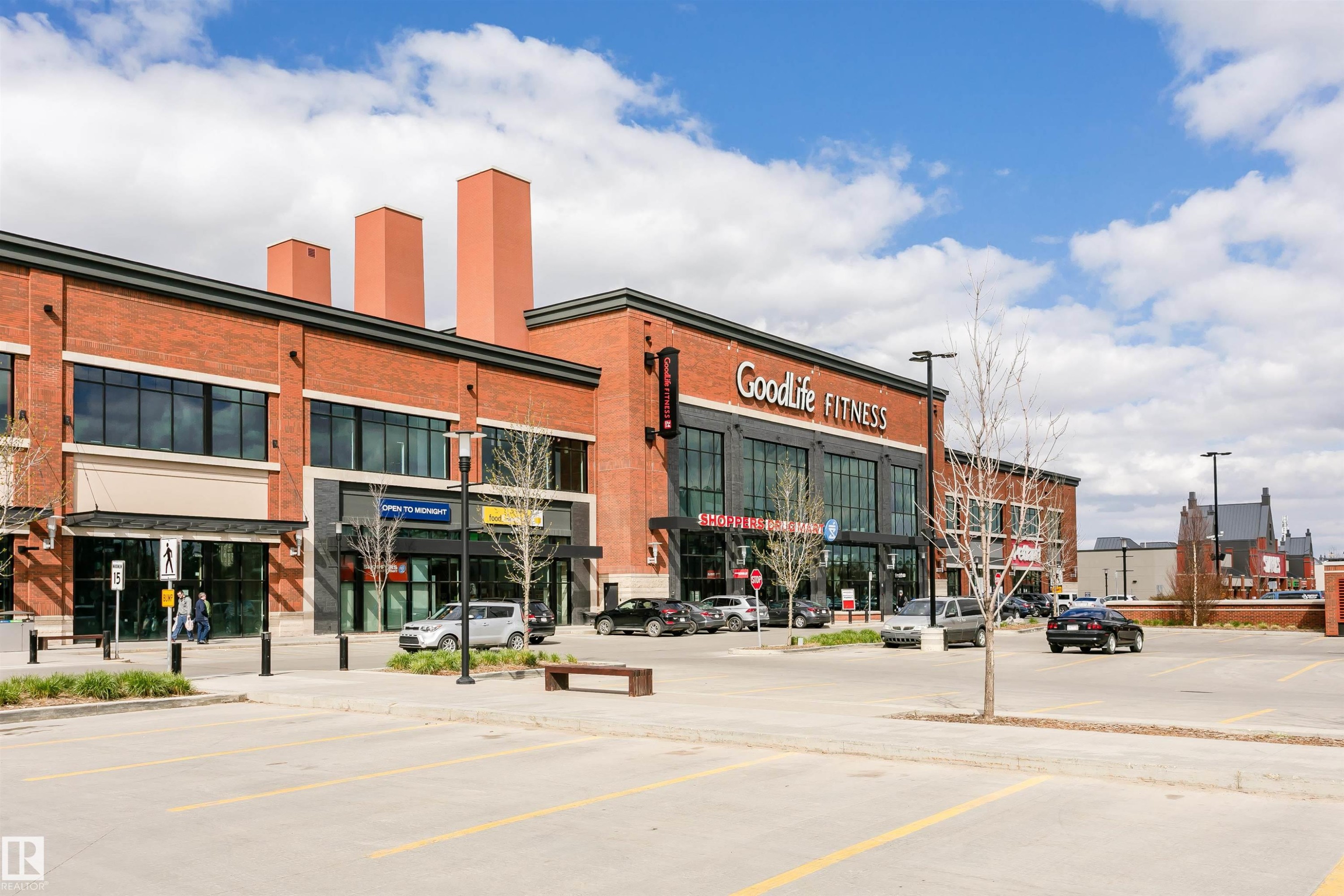 Commercial plaza featuring red brick and dark-framed storefront windows - #106 12110 106 Av Nw, Edmonton, AB - Outdoor