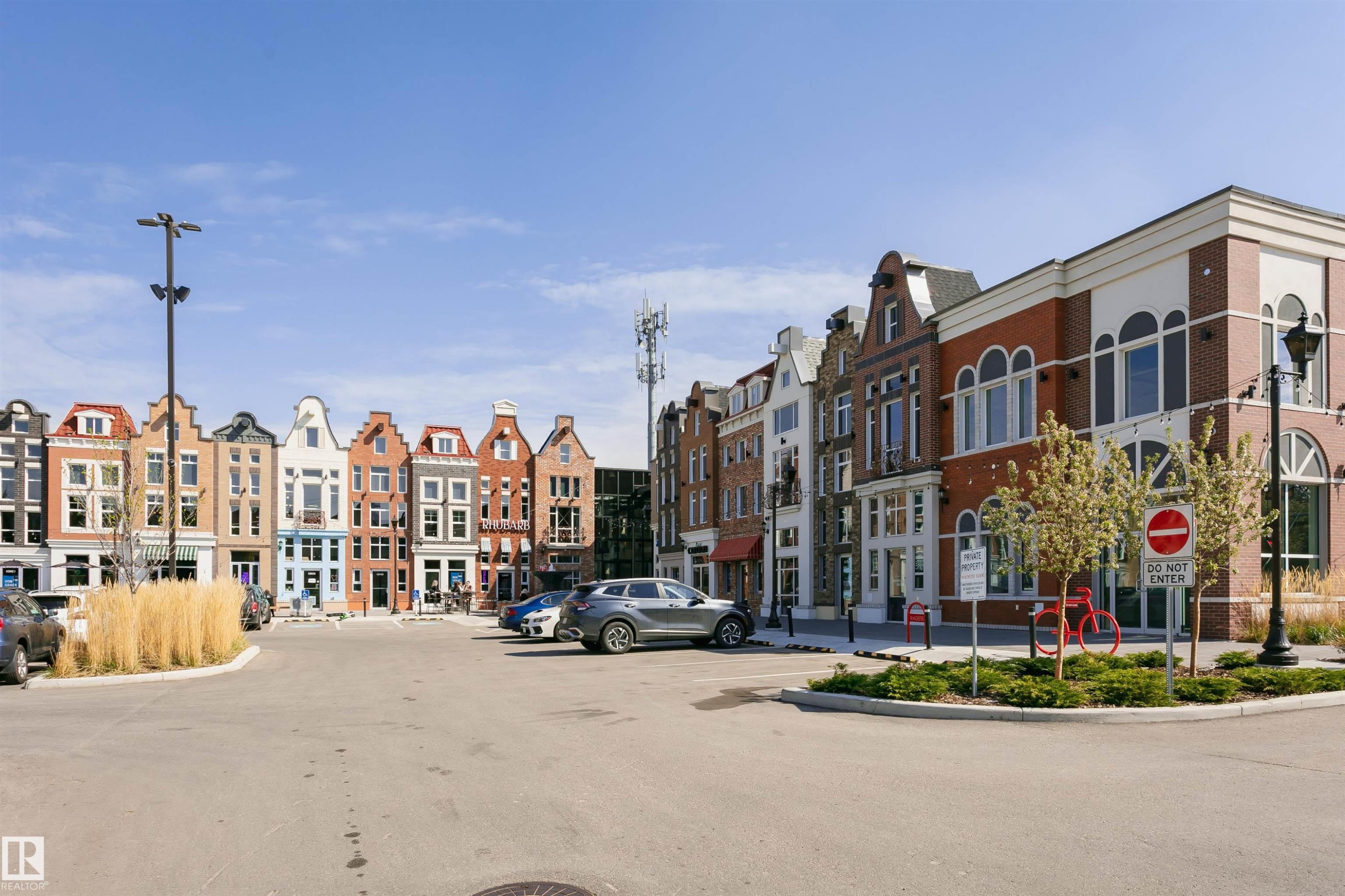 Streetscape featuring diverse architectural styles, brick and stucco facades, multiple windows, and ground-level retail spaces - #106 12110 106 Av Nw, Edmonton, AB - Outdoor With Facade