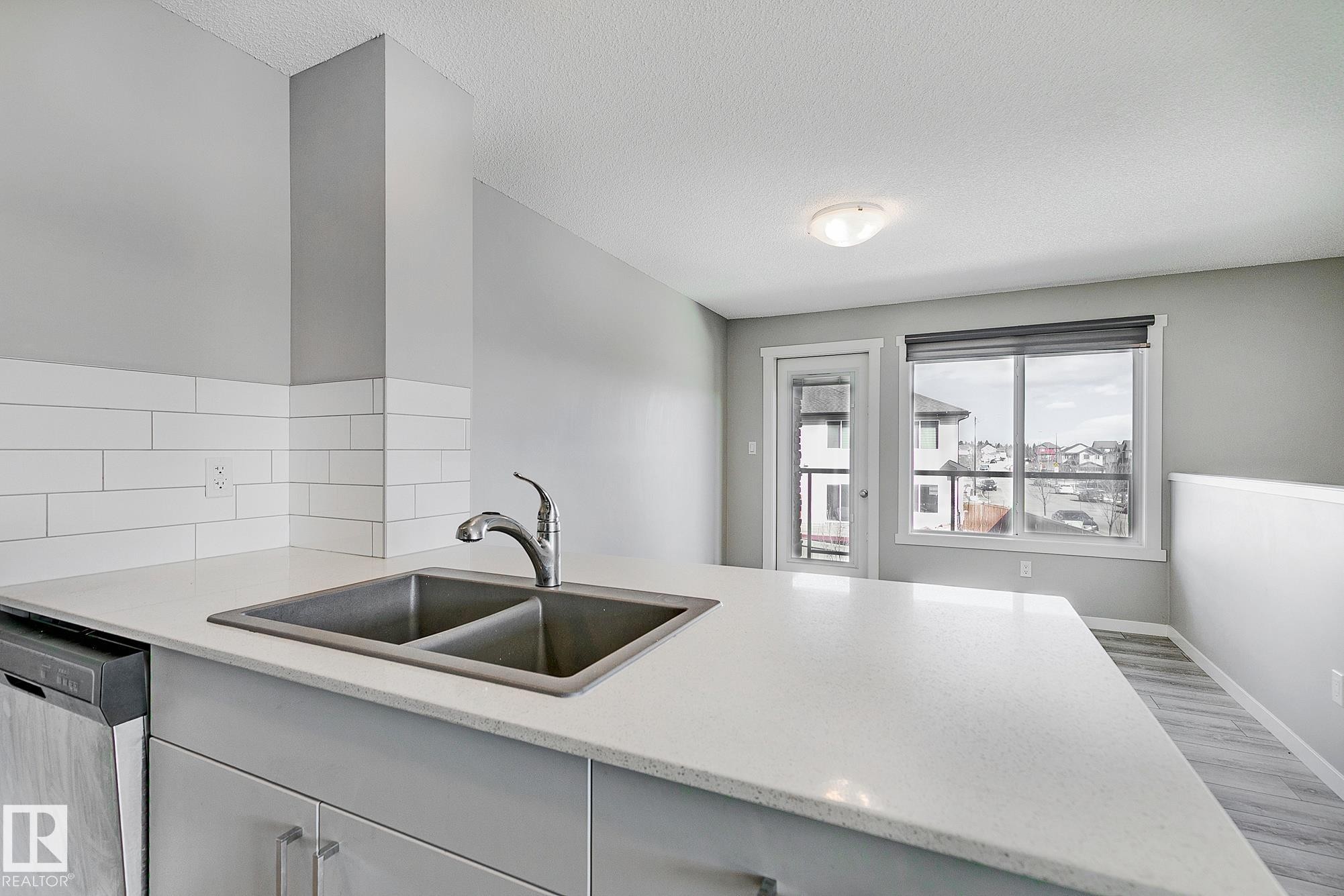 #20 1530 Tamarack Boulevard Nw, Edmonton, AB - Indoor Photo Showing Kitchen With Double Sink