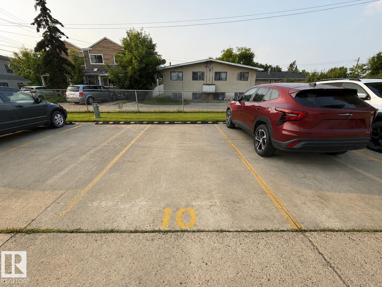 Designated parking space with clear yellow markings and number 10 - #10 4616 47 St, Leduc, AB - Outdoor