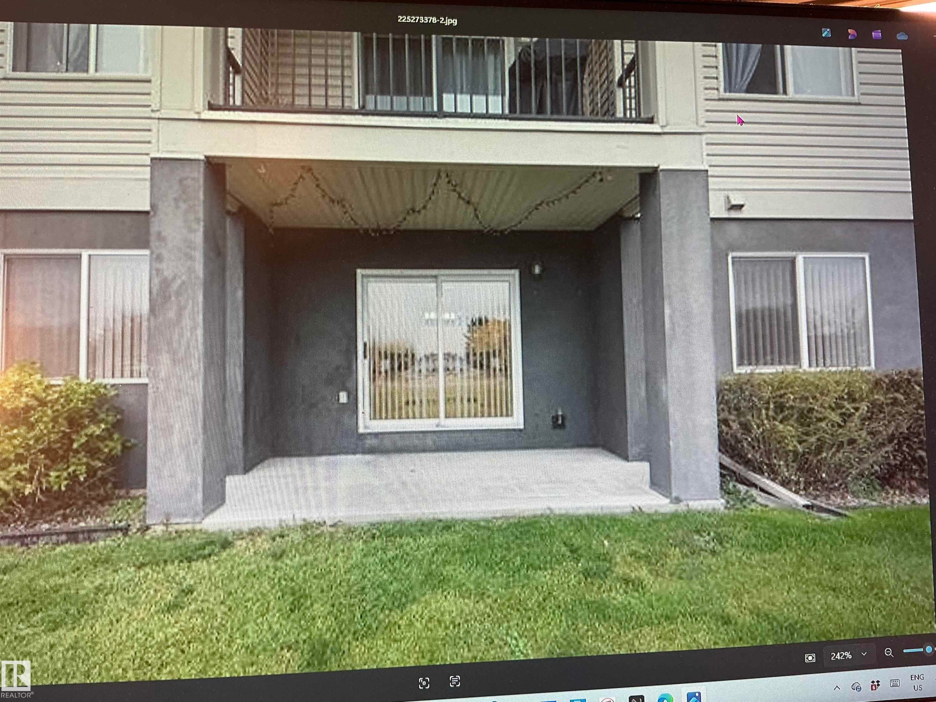 Ground-level patio with sliding glass door access - #106 592 Hooke Rd Nw, Edmonton, AB - Outdoor With Exterior