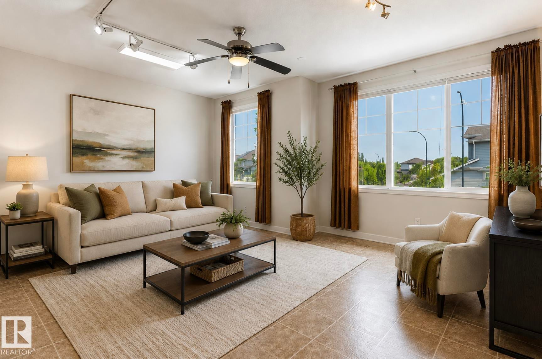 Spacious living area featuring large windows, neutral-toned wall paint, a ceiling fan, track lighting, and tile flooring - 22 Voleta Crest, Spruce Grove, AB - Indoor Photo Showing Living Room
