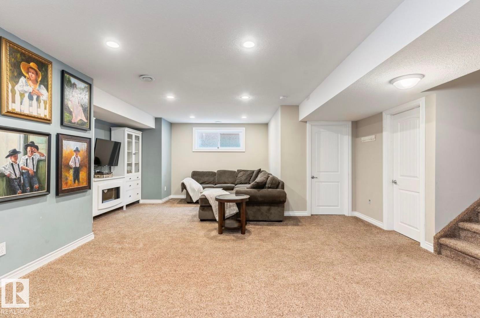 Spacious finished basement featuring neutral carpet flooring, recessed ceiling lighting, and multiple white interior doors - 22 Voleta Crest, Spruce Grove, AB - Indoor Photo Showing Basement