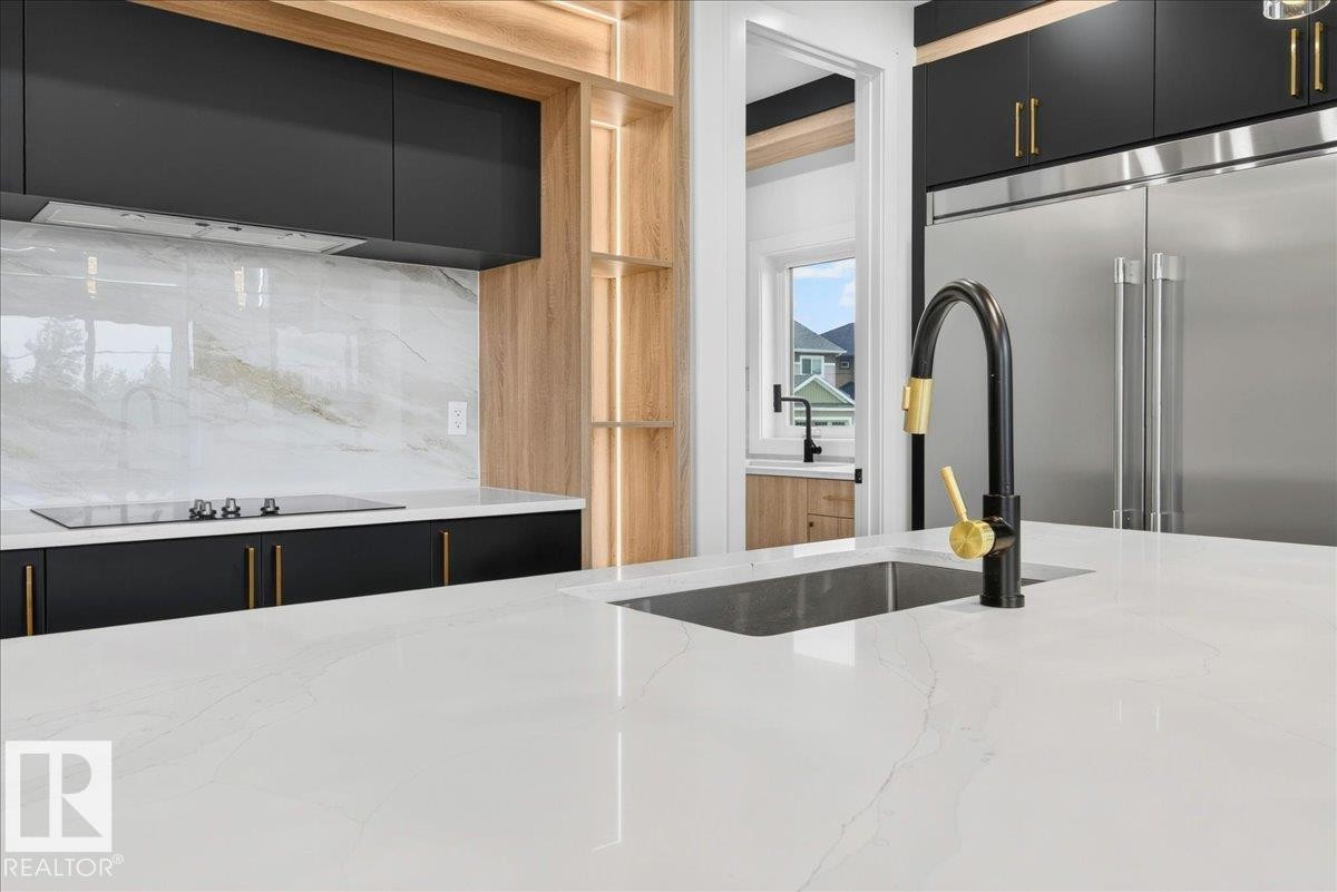 Kitchen island featuring a white countertop with subtle veining - 403 172 Avenue Nw, Edmonton, AB - Indoor Photo Showing Kitchen With Upgraded Kitchen