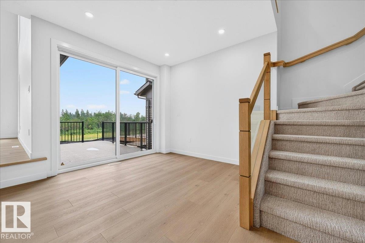 Spacious room featuring light wood-finish flooring and recessed lighting - 403 172 Avenue Nw, Edmonton, AB - Indoor Photo Showing Other Room