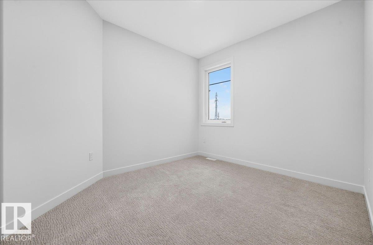Bright room featuring a single window, light-toned carpeting, white walls, and white trim - 403 172 Avenue Nw, Edmonton, AB - Indoor Photo Showing Other Room