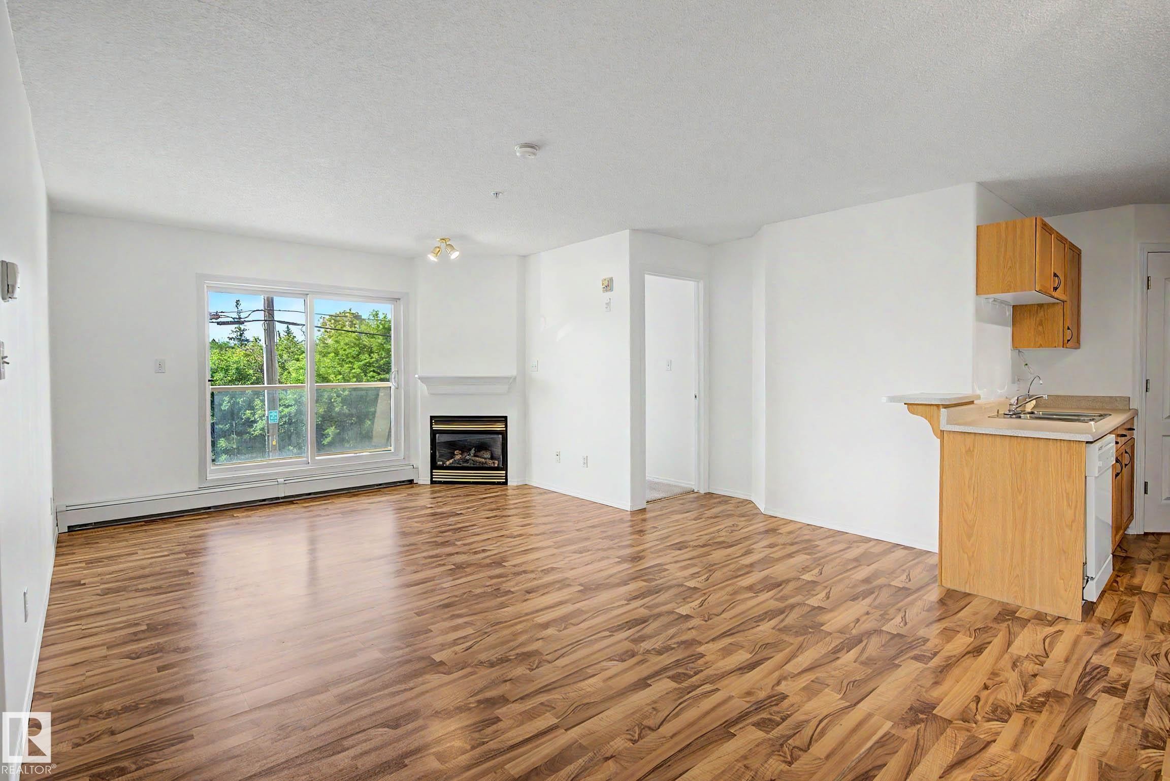#203 8119 112 Av Nw, Edmonton, AB - Indoor With Fireplace