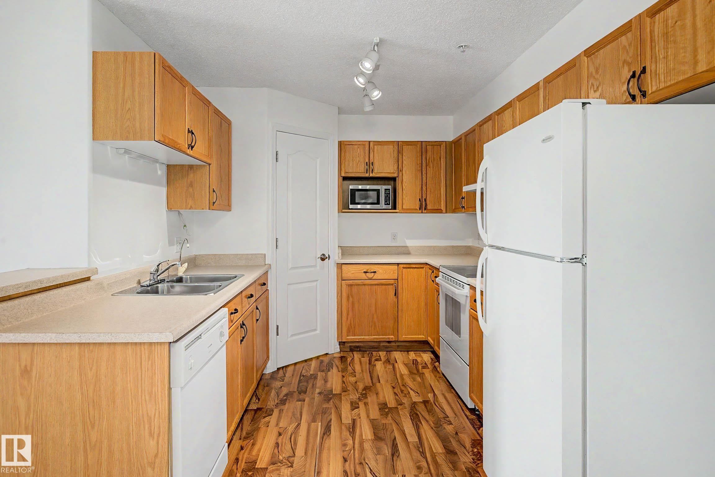 #203 8119 112 Av Nw, Edmonton, AB - Indoor Photo Showing Kitchen With Double Sink