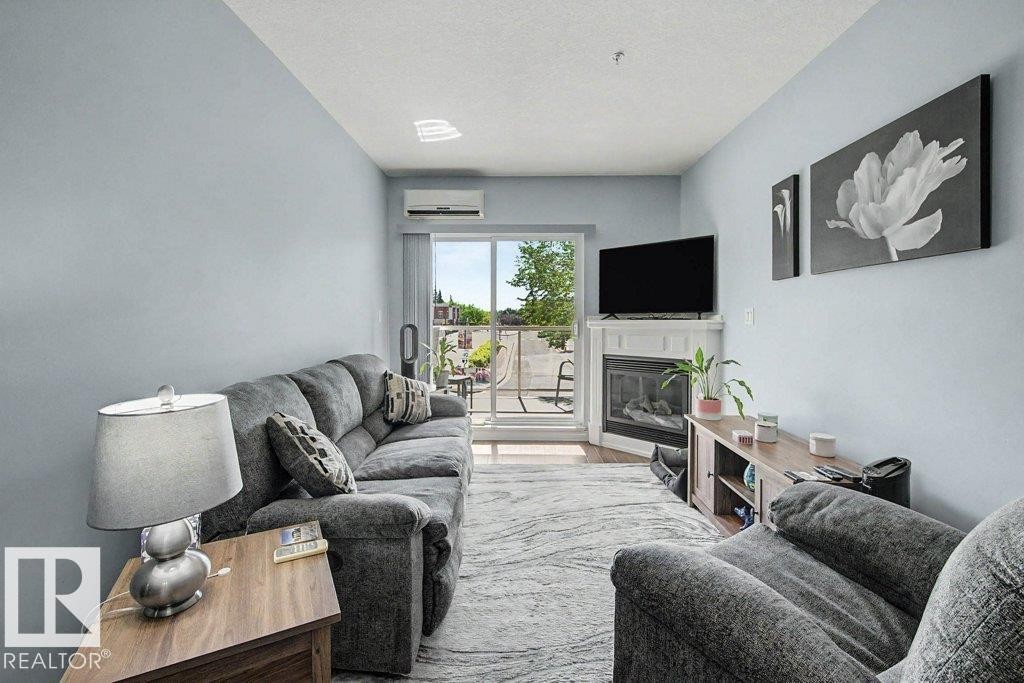 #204 5 Perron St, St. Albert, AB - Indoor Photo Showing Living Room With Fireplace