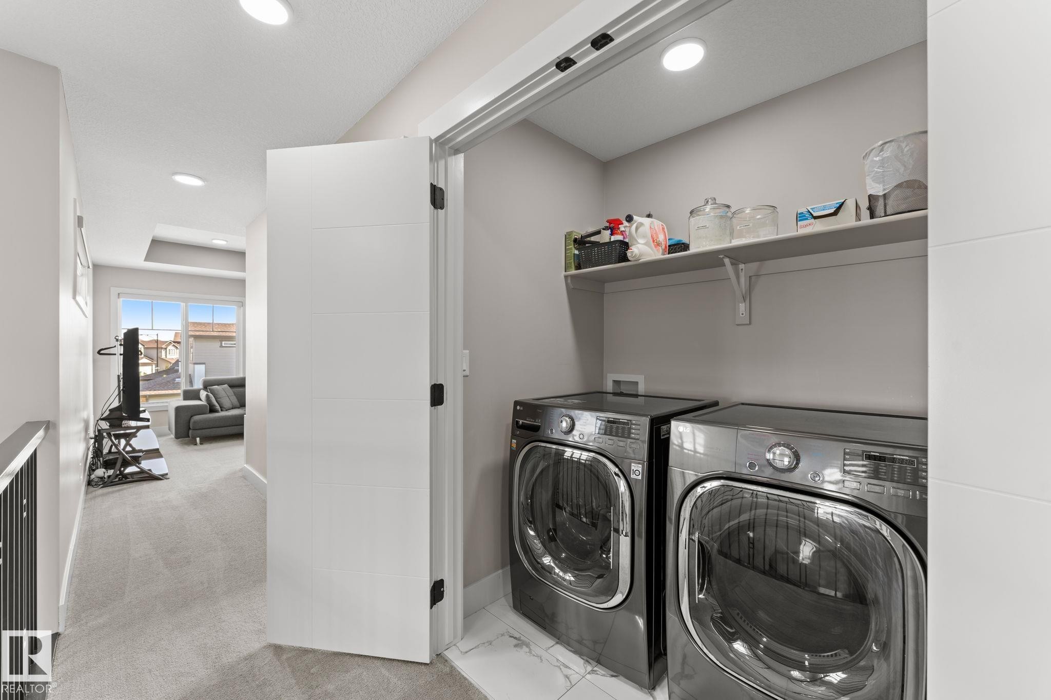 Dedicated laundry closet with shelving - 12383 176 Avenue Nw, Edmonton, AB - Indoor Photo Showing Other Room