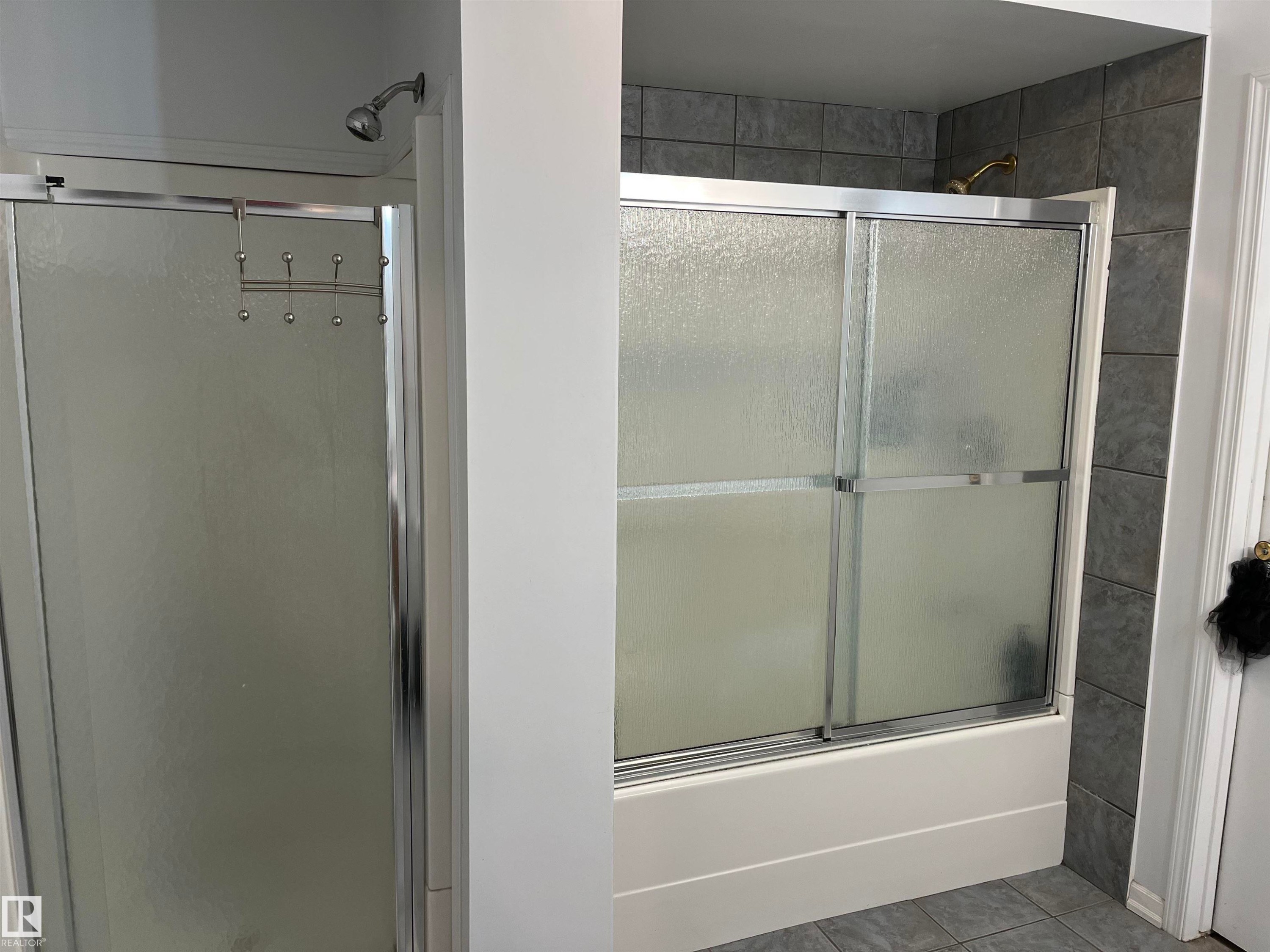 Primary Bathroom Suite Featuring Dual Shower Enclosures with Frameless Glass Doors and Chrome Hardware, Complemented by Subway Tile Accent Wall and Contemporary Fixtures Throughout - 12011 87 Avenue Nw, Edmonton, AB - Indoor Photo Showing Bathroom