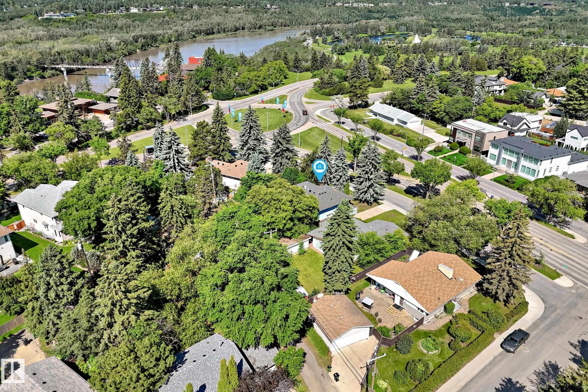 Aerial perspective showcasing a residential area with mature trees and a nearby body of water - 12011 87 Avenue Nw, Edmonton, AB - Outdoor With View