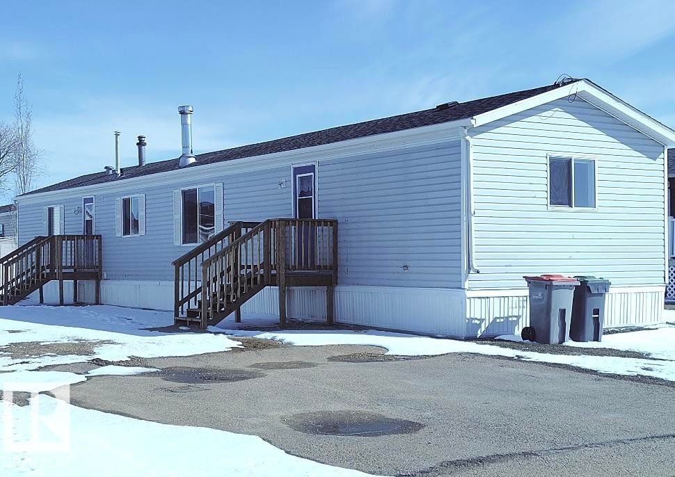 Single-story residence featuring light blue siding and a dark shingle roof - 42 Midland Road, Millet, AB - Outdoor With Exterior