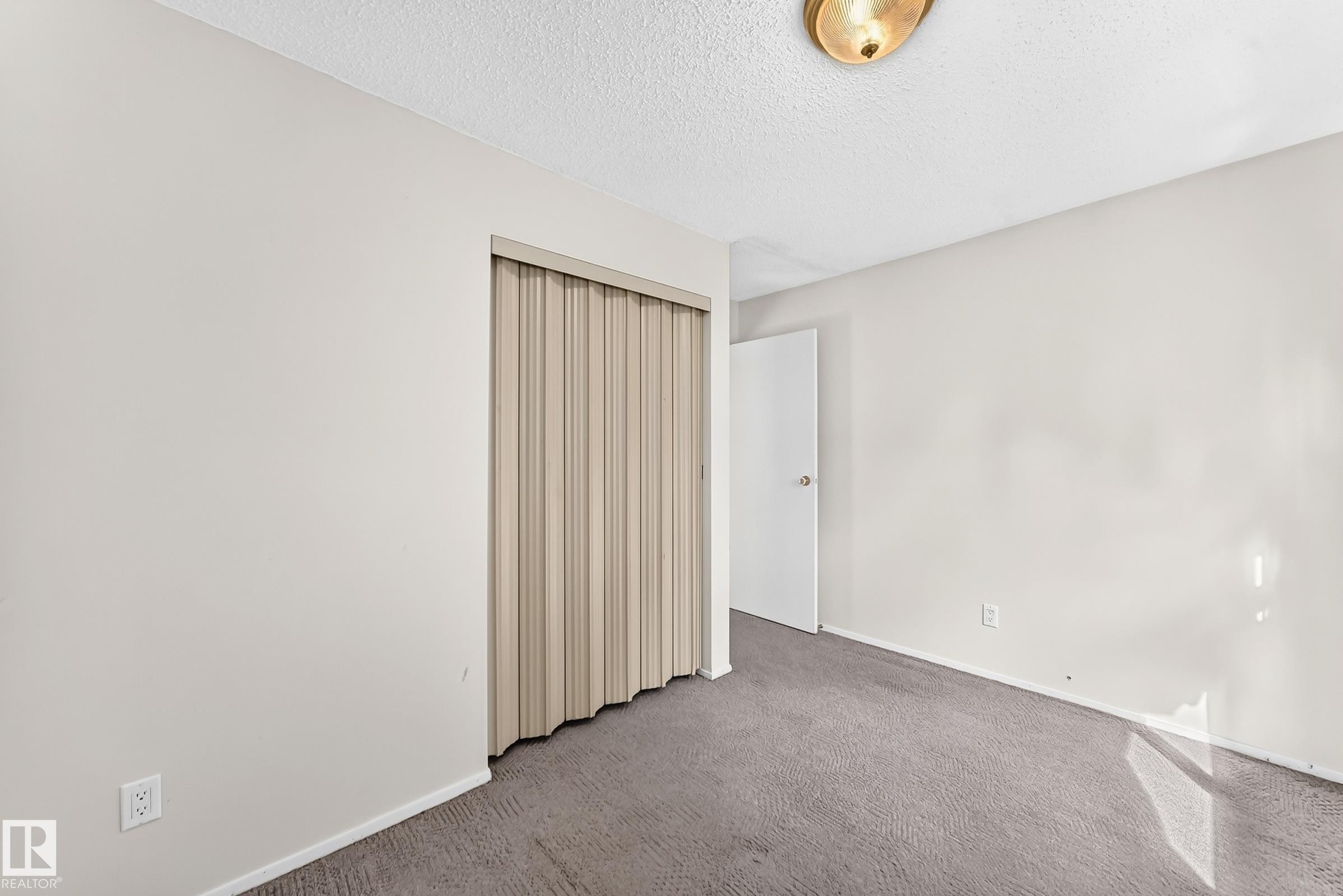 Interior room featuring light gray wall paint, gray carpeting, and a white ceiling - 290 Lancaster Terrace Nw, Edmonton, AB - Indoor Photo Showing Other Room