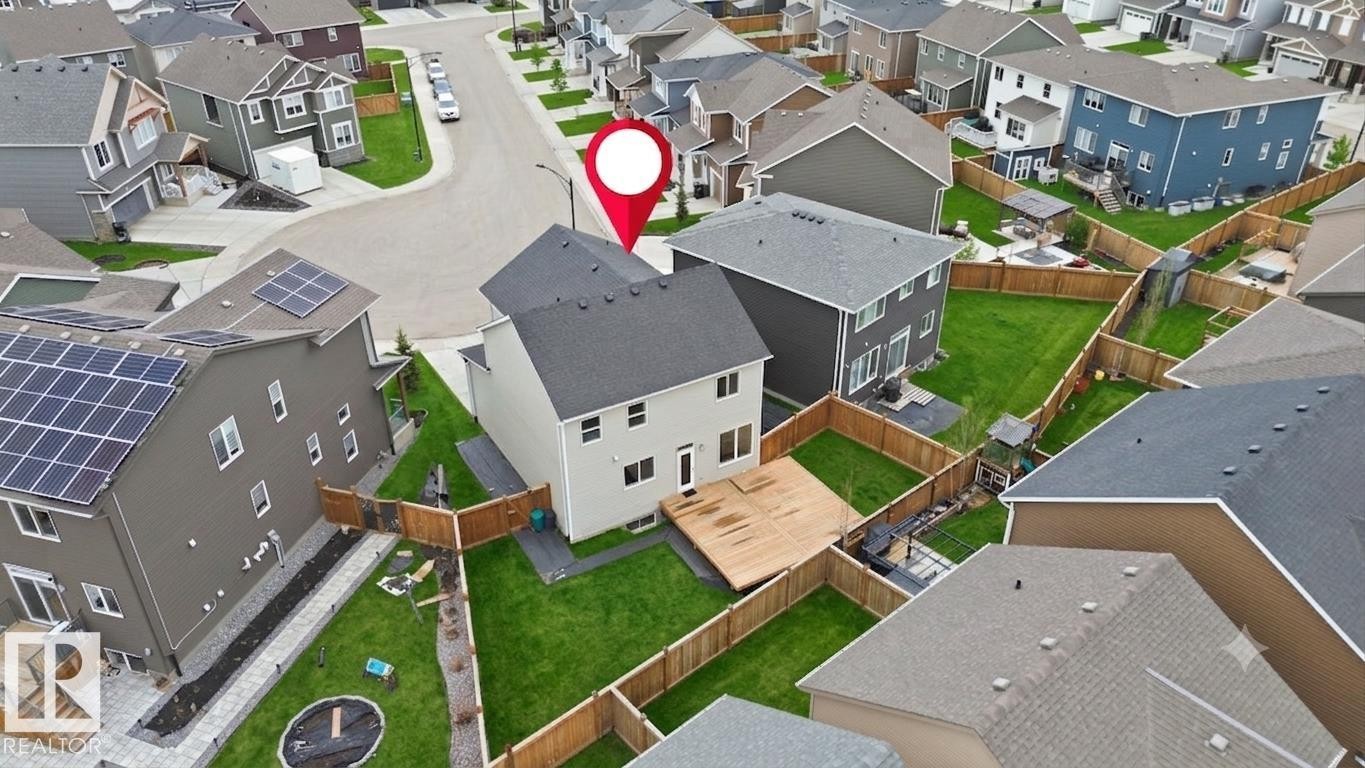 Modern two-story residence featuring a clean architectural design with a light-colored exterior, pitched roofline, and multi-pane windows - 1607 202 Street Nw, Edmonton, AB -