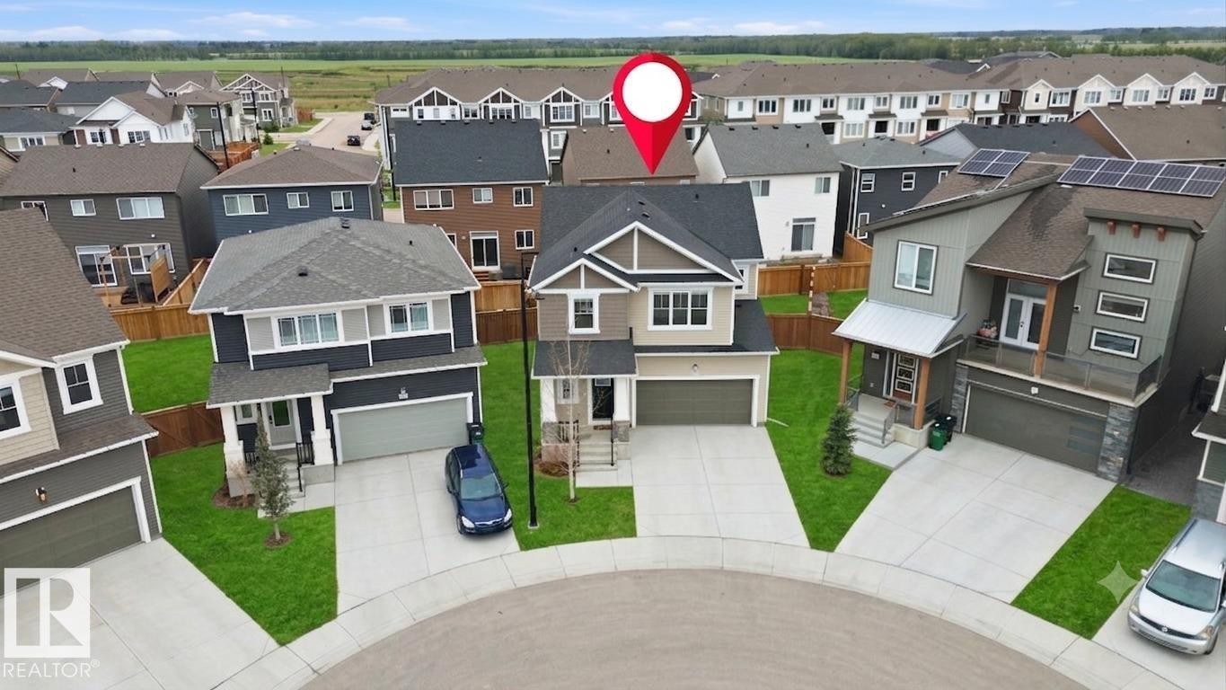 Two-story residence featuring a neutral-toned facade and a dark shingle roof - 1607 202 Street Nw, Edmonton, AB - With Facade