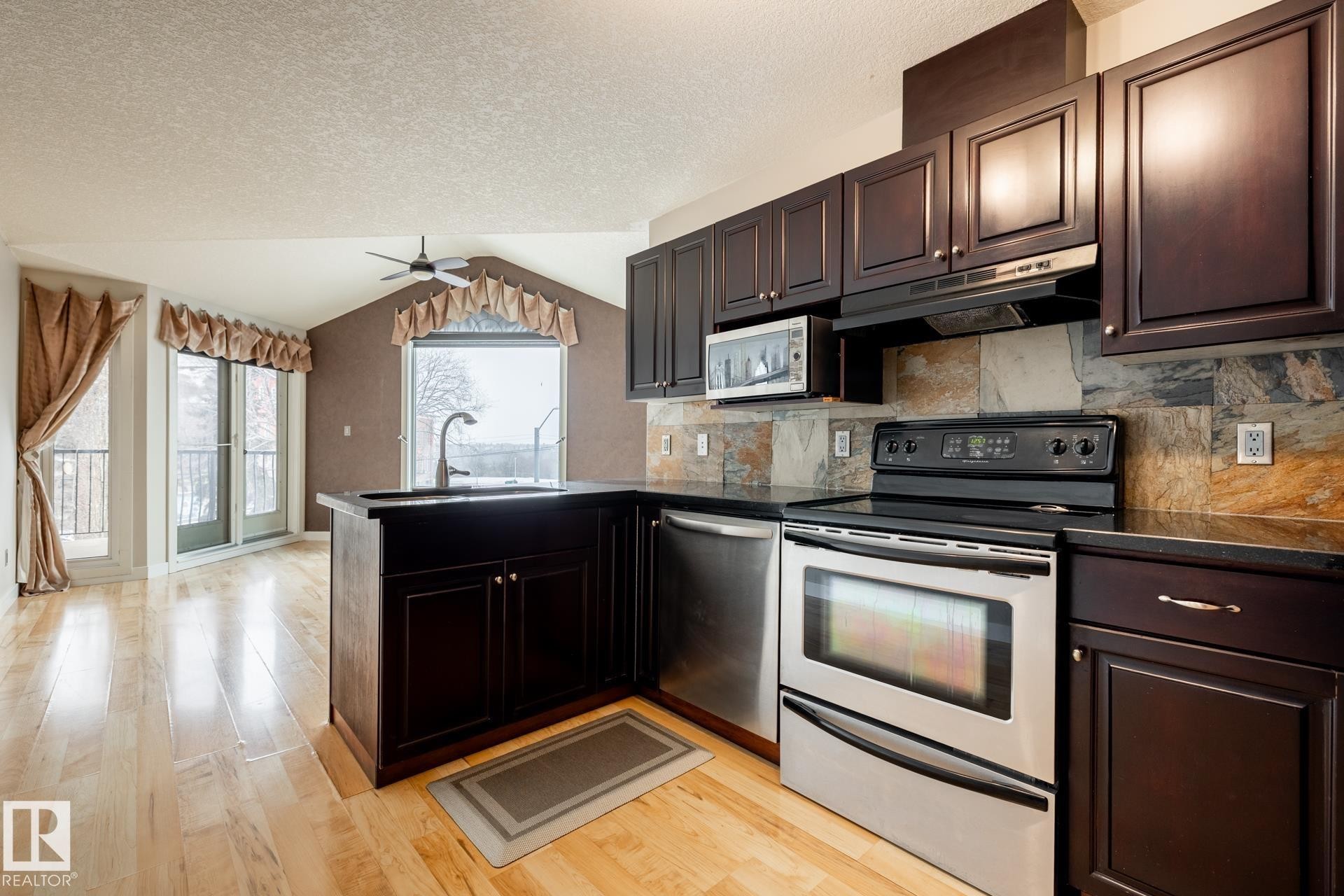 #304 9336 Jasper Av Nw, Edmonton, AB - Indoor Photo Showing Kitchen With Stainless Steel Kitchen