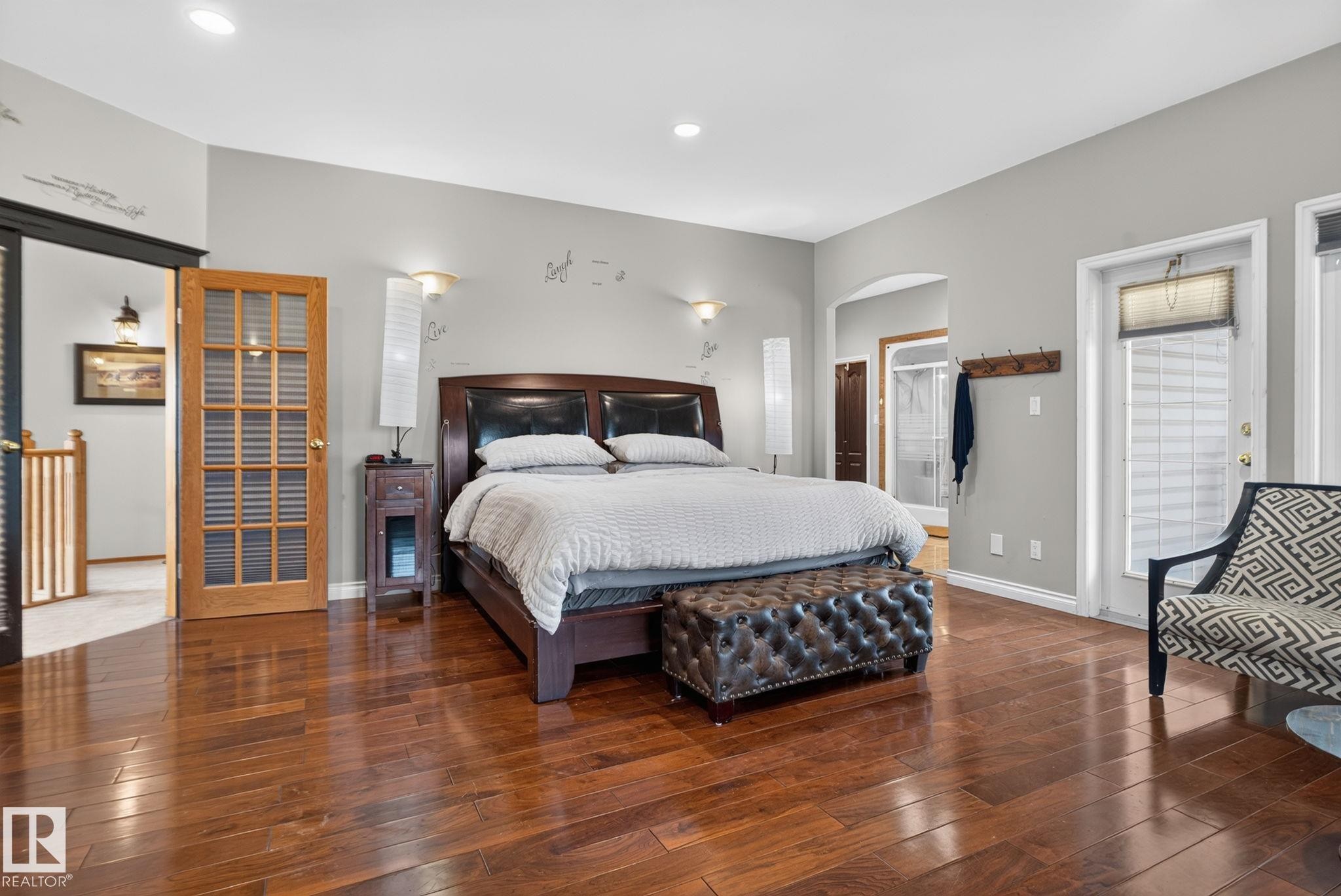 Hardwood flooring throughout featuring recessed lighting, a French door with transom, and an exterior door with integrated blinds - 50336 Range Road 280, Rural Leduc County, AB - Indoor Photo Showing Bedroom