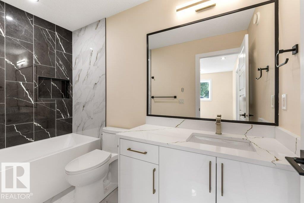 3rd Bath - Upper Floor 4 Piece Bath - Contemporary primary bathroom featuring a floating white vanity with dual rectangular vessel sinks, quartz countertop, and matte black hardware - 10323 79 Street Nw, Edmonton, AB - Indoor Photo Showing Bathroom